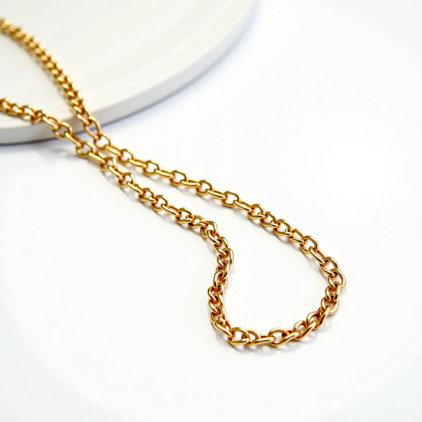 This gold chain features a series of interlocking oval links, giving it a classic and elegant design. The chain appears to be crafted from gold, characterized by its lustrous golden hue. It does not incorporate any gemstones or elaborate settings, focusing instead on the simplicity and beauty of the linked pattern. The clasp type is not visible from the angle shown, emphasizing the seamless design of the chain. Overall, this piece showcases a timeless aesthetic, suitable for various occasions.