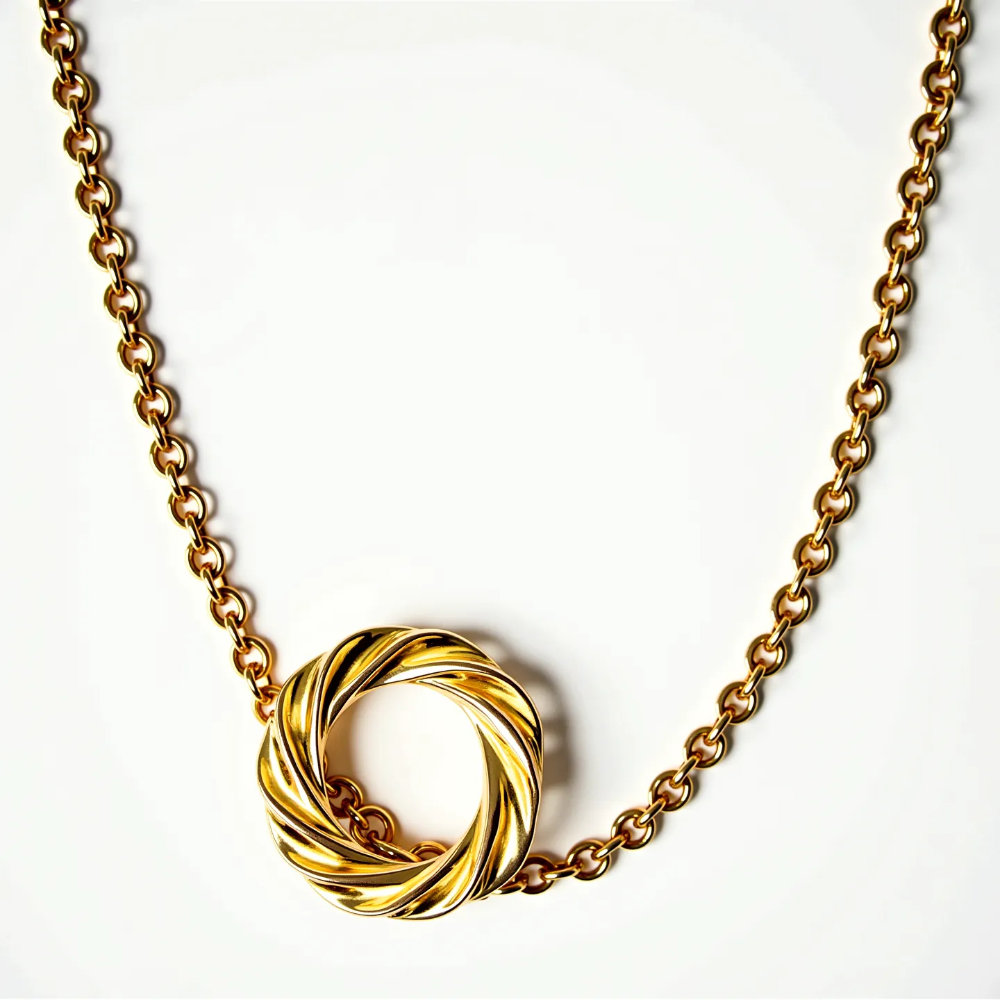 This gold chain features a series of interconnected, polished gold links that provide a sleek and classic appearance. Suspended from the chain is a notable centerpiece, a round pendant with an intricate, twisted design that adds a touch of elegance and uniqueness to the piece. The gold used throughout the chain and pendant showcases a lustrous finish, enhancing the overall luxurious feel. The chain likely includes a secure clasp mechanism, allowing for easy fastening and removal, although the specific type is not visible. This piece exemplifies sophistication through its simple yet eye-catching design.