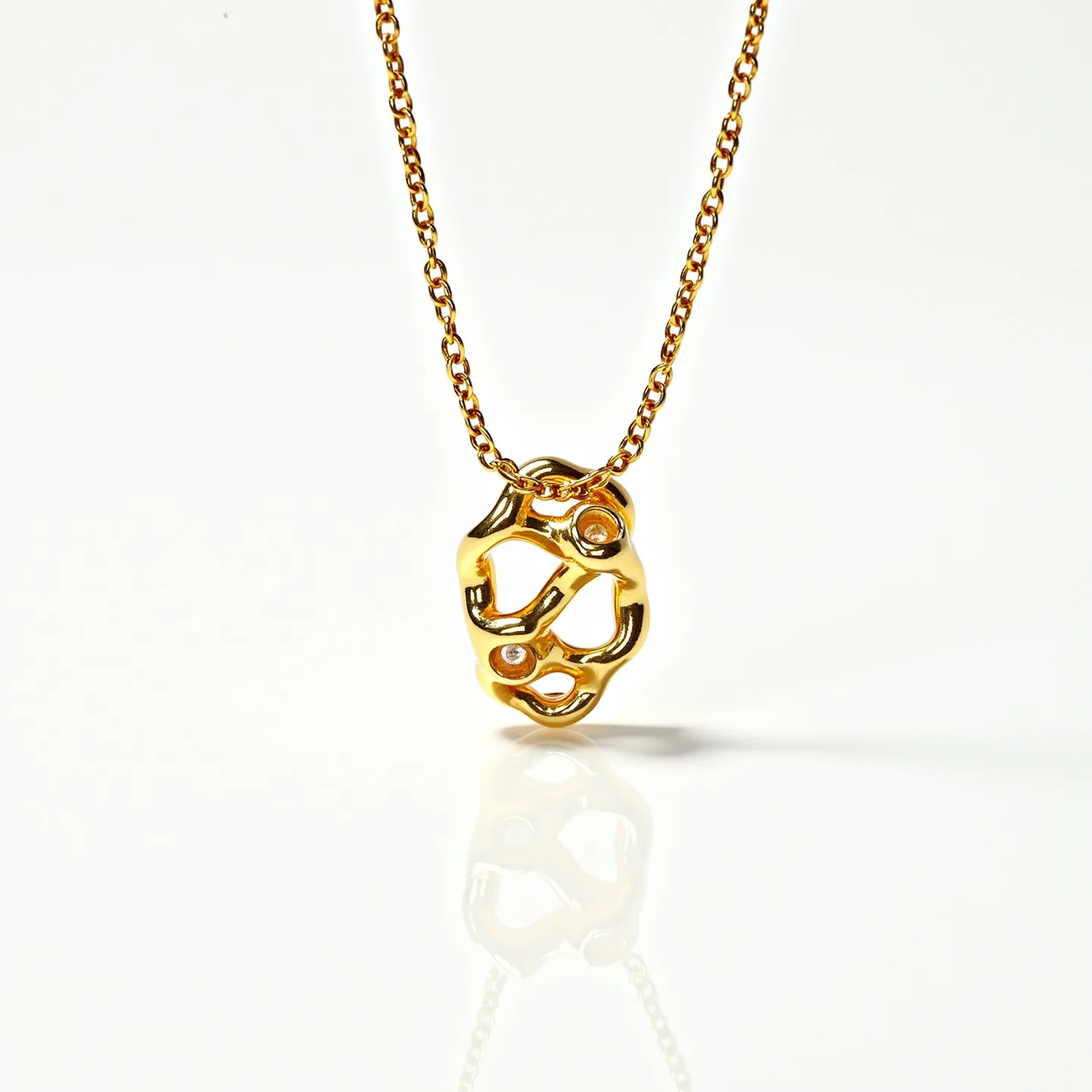 This gold chain features a delicate link design, highlighting a polished gold pendant with an abstract, organic shape. The pendant is adorned with small round-cut gemstones, likely diamonds, that are bezel-set within the design for added sparkle and elegance. The chain appears to be made of yellow gold, which complements the shiny finish of the pendant. Although not visible, the chain is likely to have a secure clasp for closure, common in fine jewelry pieces. Overall, this piece exudes a sense of contemporary sophistication and artistry.