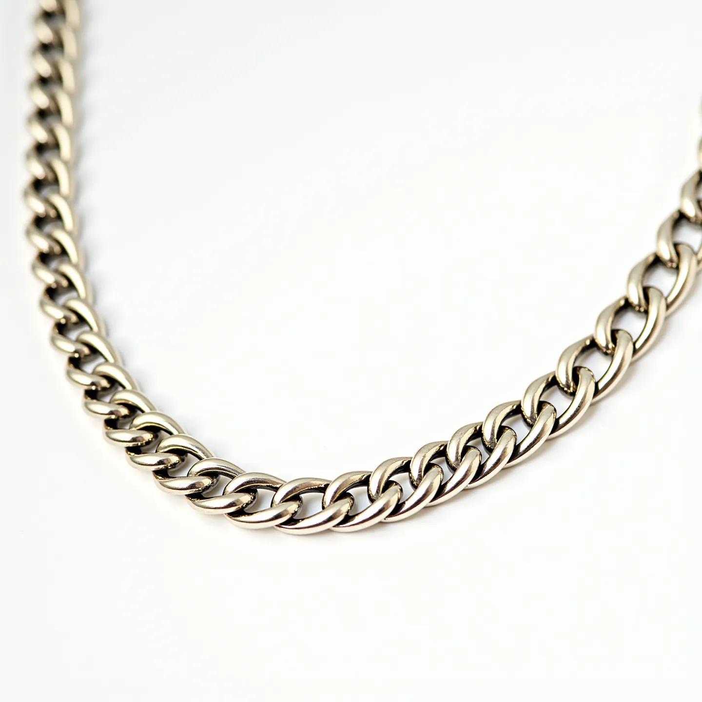 This gold chain necklace features a classic curb link design, crafted from polished gold that gives it a sleek and elegant appearance. The links are tightly interlocked, ensuring durability and a subtle shine that reflects light beautifully. There are no additional gems or stones embedded in the design, which focuses on the simple elegance of the gold material itself. The clasp type is not visible, but the seamless style suggests a discreet fastening mechanism that complements the streamlined look of the necklace.