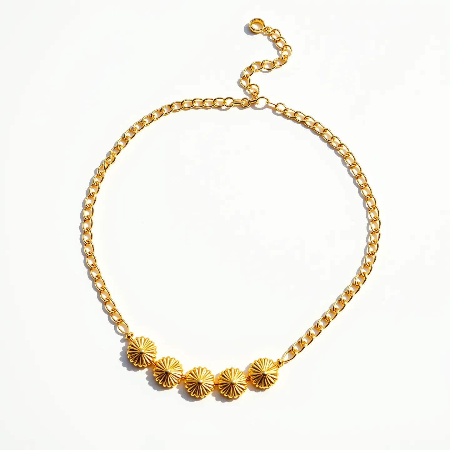 This gold chain necklace features a series of interlocking links with a polished finish, giving it a sleek and shiny appearance. In the center, it is adorned with five decorative disc-shaped elements, each designed with a radial pattern that resembles a sunburst motif, adding an intricate detail to the overall aesthetic. The necklace is secured with a lobster clasp, ensuring a secure and adjustable fit for the wearer. Its design combines elegance with a touch of artistic creativity, making it suitable for various occasions.