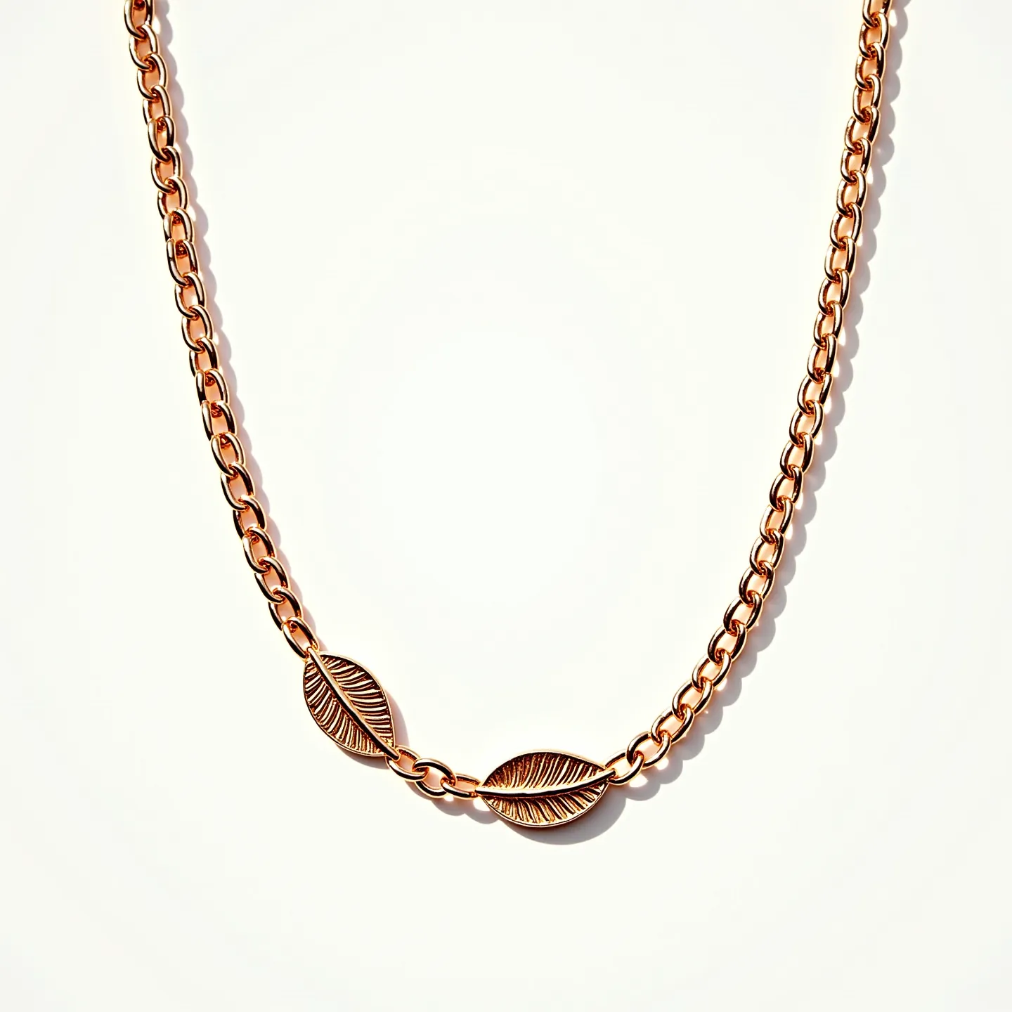 This gold chain necklace features a series of interlocking links crafted from polished gold, showcasing a classic and elegant design. Integrated into the necklace are two decorative leaf-shaped elements that add a unique and artistic flair to the overall piece. Each leaf features a detailed texture, enhancing the visual appeal without the inclusion of gems or stones. The necklace is equipped with a standard clasp, ensuring a secure fit while maintaining the seamless aesthetic of the design.