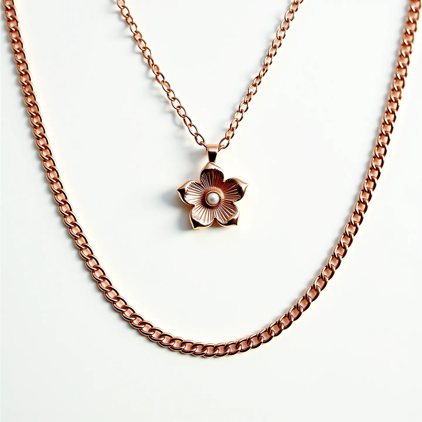 This gold chain necklace features a delicate flower-shaped pendant with a central pearl, adding a touch of elegance and sophistication. The chains are crafted with a polished rose gold finish, creating a warm and luxurious appearance. The pendant's flower design showcases intricate detailing, enhancing its visual appeal. The necklace likely includes a secure clasp to ensure it stays comfortably in place when worn. The combination of rose gold and the central pearl makes this necklace a versatile accessory suitable for various occasions.