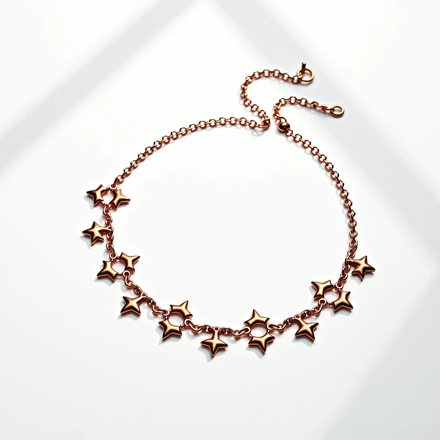 This gold choker necklace features a delicate chain adorned with star-shaped gold accents evenly spaced along its length. The stars add a playful and elegant touch, contributing to the necklace's overall design. It is crafted from gold, though it has no visible gems or stones. Each star is linked together, maintaining flexibility and comfort when worn. The necklace secures with a standard lobster clasp, allowing for adjustable sizing and ease of use.