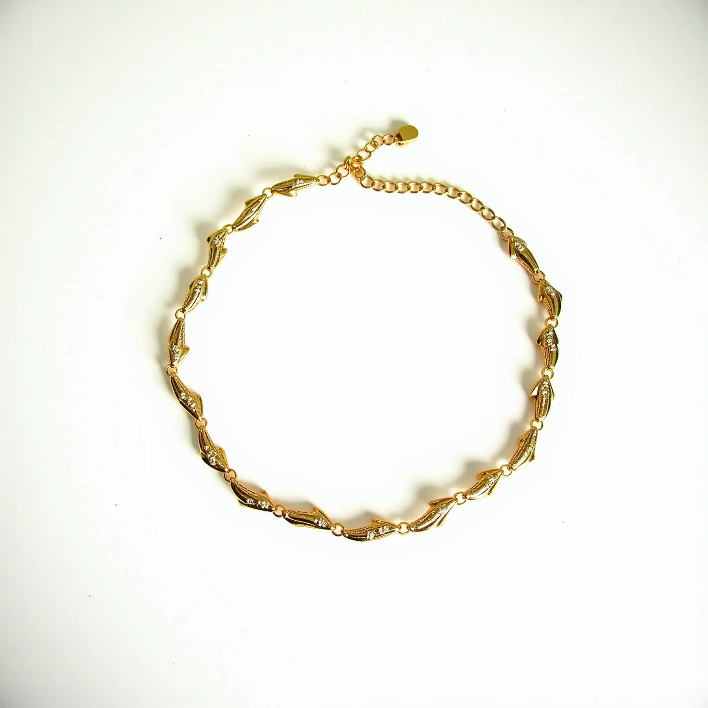 This gold choker necklace features a series of intricately shaped gold links, showcasing an elegant design that appears to alternate between solid gold segments and gold segments with embedded details. The necklace includes small, white stones that add a subtle sparkle, set within each link. The stones appear to be small round cut gems, possibly cubic zirconia or small diamonds, enhancing the overall luxurious appearance. The necklace is finished with an adjustable chain link clasp, allowing for a customizable fit, and a small teardrop-shaped end piece that completes the sophisticated look.