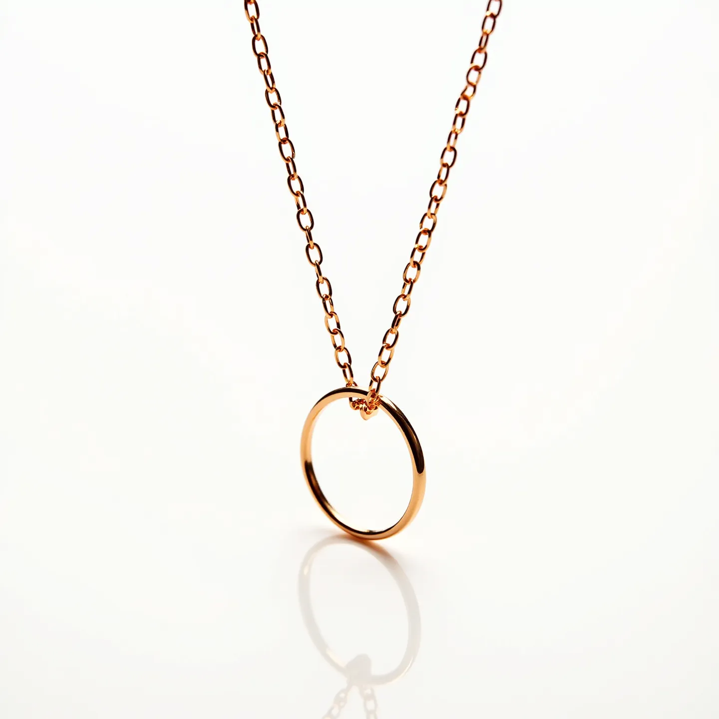 This gold circle necklace features a simple yet elegant design, with a polished gold circle pendant suspended from a delicate gold chain. The chain is composed of a series of interlinked oval links, providing a subtle texture and shimmer that complements the central circular motif. The necklace appears to be made of a fine gold material, emphasizing a classic and timeless aesthetic. It is completed with a standard clasp mechanism, ensuring a secure and adjustable fit for various wearers. The minimalistic design of this necklace makes it versatile, suitable for both everyday wear and special occasions.