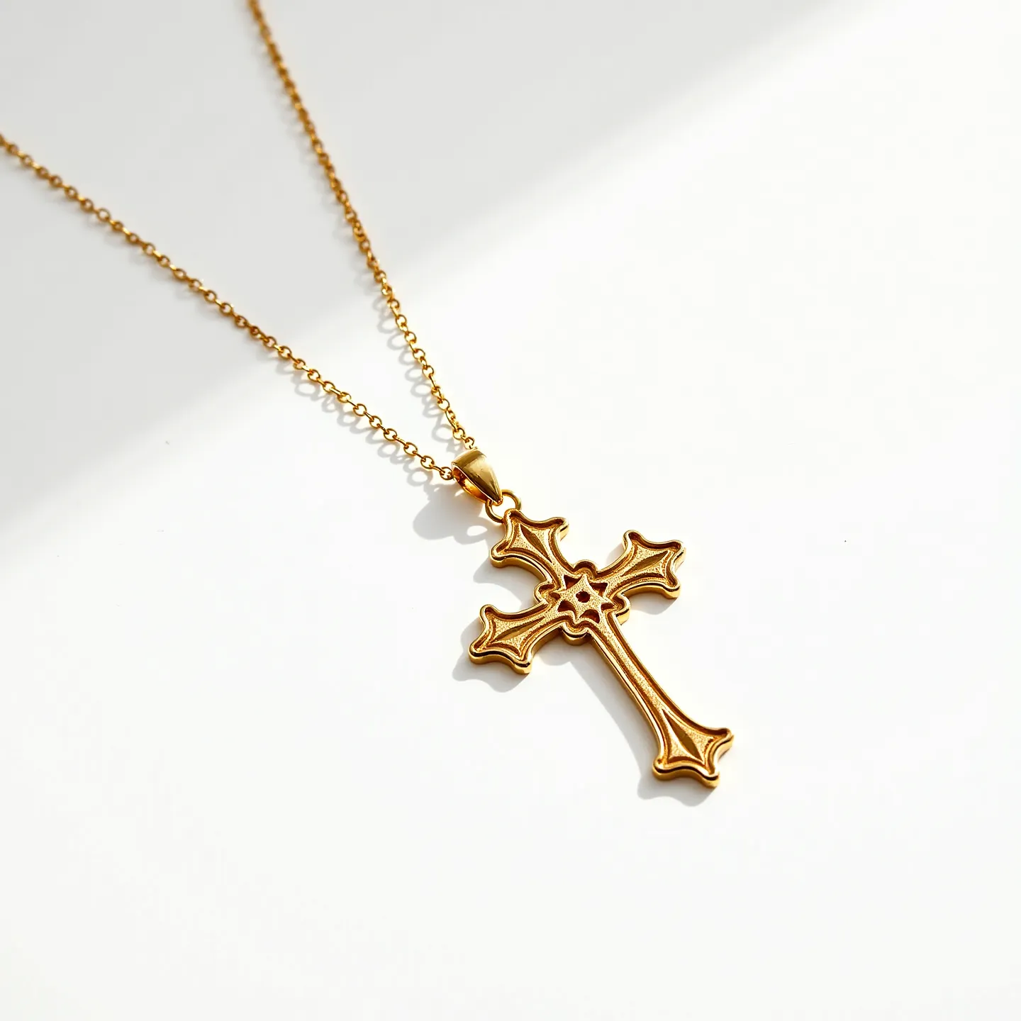 This gold cross necklace features an ornate cross pendant crafted from polished gold, showcasing an intricate design with curved and detailed edges. The center of the cross contains a floral motif, adding an elegant touch to its overall appearance. The pendant hangs from a fine gold chain, known for its delicate and elegant design that complements the pendant's style seamlessly. The necklace includes a simple bail that connects the pendant to the chain, ensuring a secure attachment and allowing smooth movement.