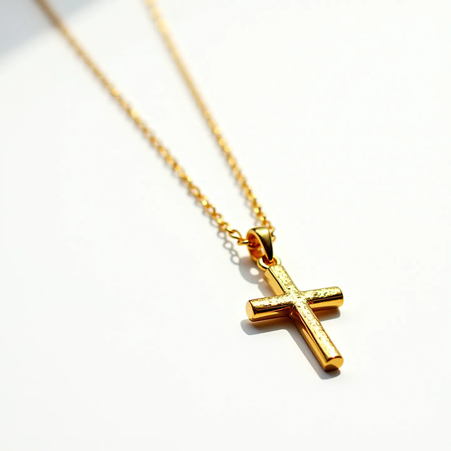 This gold cross necklace features a polished gold chain with a simple yet elegant cross pendant. The pendant appears to be crafted from the same gold material, with a smooth, reflective finish that enhances its shine. The cross is attached to the chain by a small, secure gold bail, ensuring that it hangs neatly. There are no visible gemstones or additional embellishments on the cross, emphasizing its sleek and classic design. The chain is likely secured with a standard spring ring clasp, completing the understated elegance of the piece.