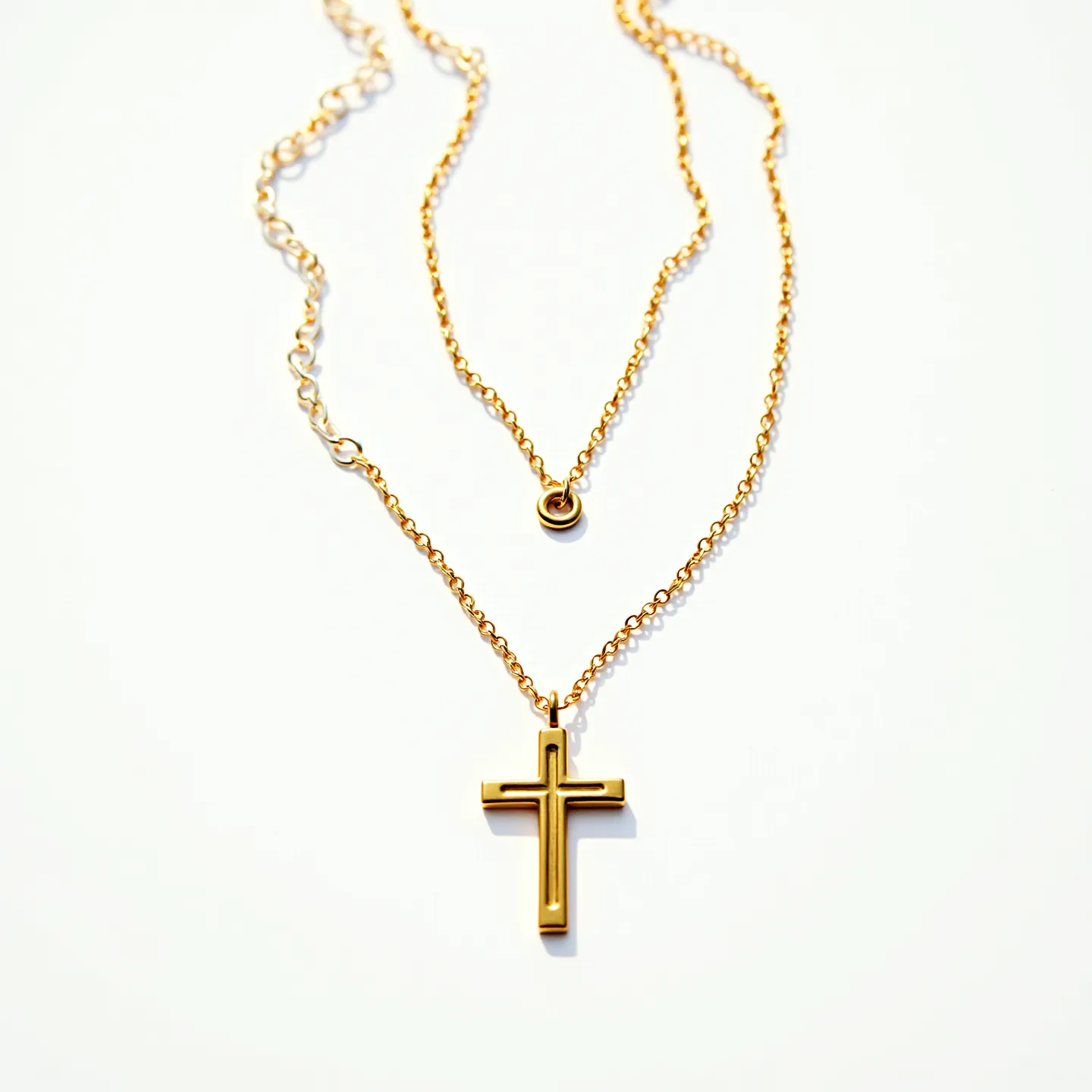 This gold cross necklace features a simple yet elegant design with a polished gold cross pendant suspended from a delicate gold chain. The cross showcases a sleek, modern style with smooth edges and a refined finish. The necklace includes a small round gem in a bezel setting near the top, adding a subtle touch of sparkle. The chain appears to have a lobster claw clasp, ensuring secure wear and easy removal. Overall, the necklace's minimalist aesthetic and quality materials make it a timeless accessory.