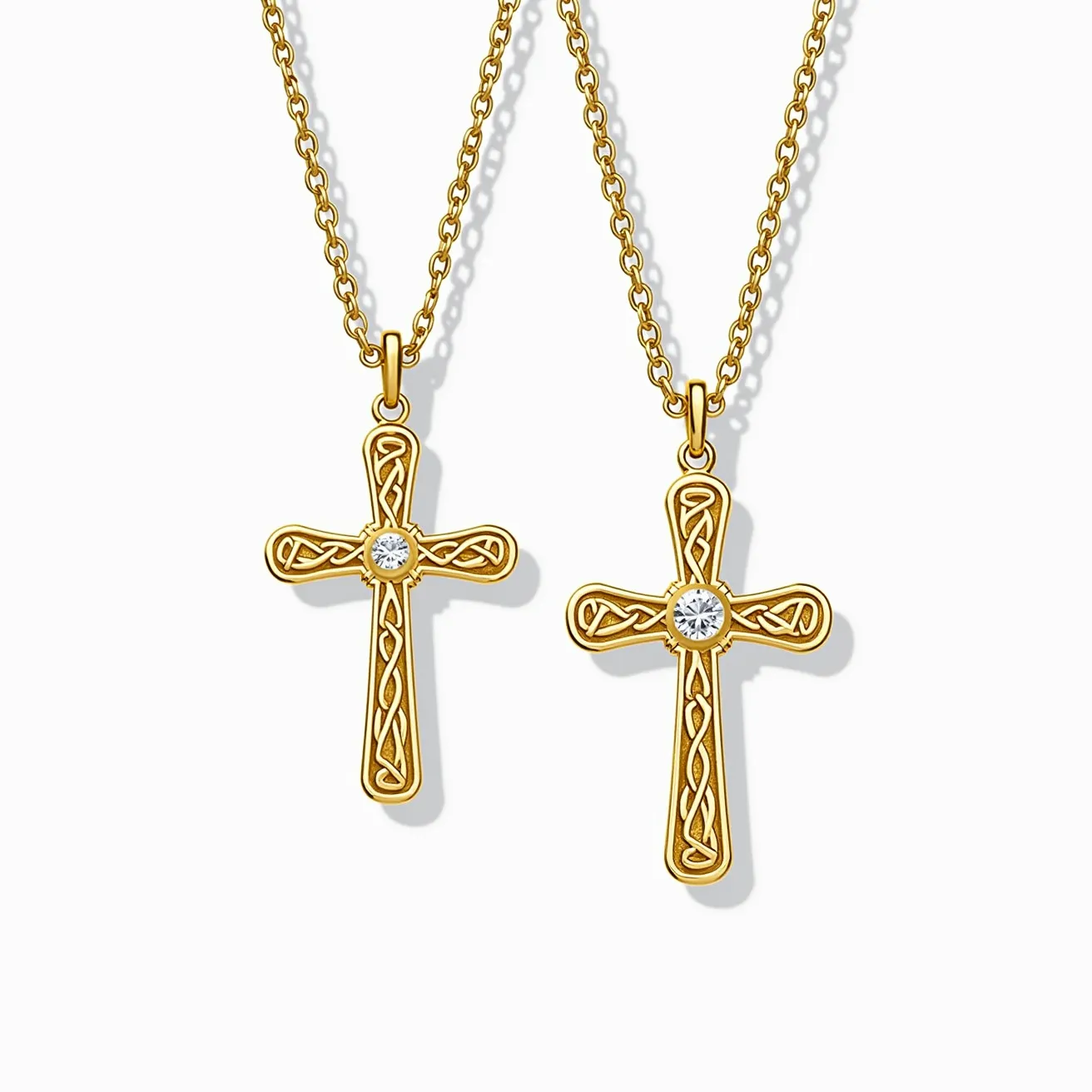 These gold cross necklaces feature an intricately designed cross pendant made of polished gold, embellished with a single, round-cut stone set at the intersection of the cross. The stone, likely a diamond or a cubic zirconia, is securely held in a bezel setting that adds a subtle sparkle to the piece. The cross itself is adorned with detailed patterns that add to its elegance. The necklaces include a classic cable chain, which is connected to the pendant via a simple yet sturdy bail, providing both functionality and style.