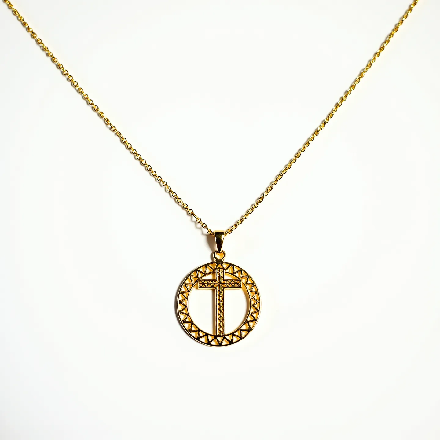 This gold cross necklace features a circular pendant with a meticulously designed cross at the center, crafted from gold, giving it a luxurious appearance. The cross is encompassed by a textured circular frame, adding an intricate detail to the design. The pendant hangs from a fine gold chain, which is elegantly linked, suggesting durability and style. This necklace is equipped with a standard lobster clasp, providing secure and easy wearability. The overall craftsmanship and use of gold make this piece of jewelry both an elegant and timeless accessory.