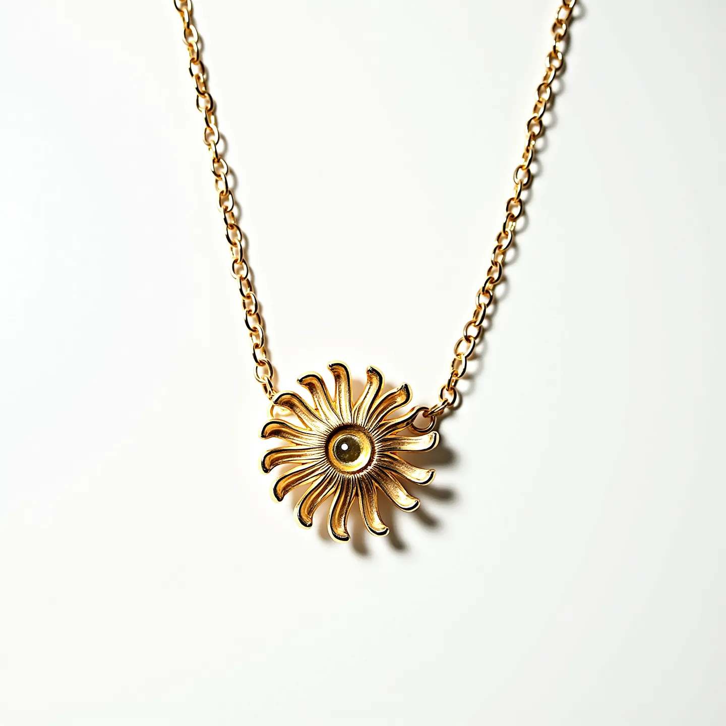 This gold flower necklace is intricately designed, featuring a central flower motif crafted from polished gold. The petals are elegantly curved, each with a smooth, reflective surface that enhances the necklace's shimmering quality. At the center of the flower, a single round gemstone is set, adding a focal point of interest with its glossy finish. The gem is held securely in place with a bezel setting, allowing it to sit flush against the gold background. The chain is composed of interlocking gold links that provide a seamless and fluid movement when worn. The necklace is completed with a traditional lobster clasp for secure fastening, ensuring both style and practicality.