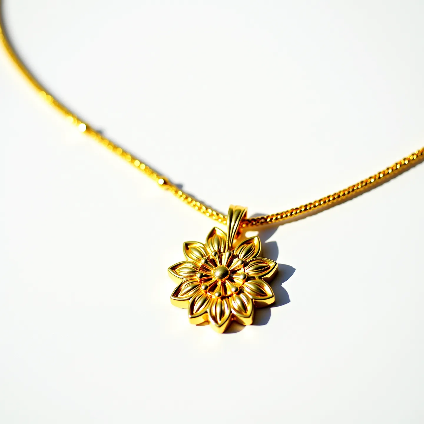 This gold flower necklace showcases a beautifully crafted floral pendant made of a lustrous gold material, featuring intricately detailed layered petals that create a striking and elegant design. The pendant hangs from a finely woven gold chain, which likely has a polished finish to match the pendant’s shine, emphasizing the luxurious appearance of the piece. Each petal of the flower is meticulously shaped to capture light, enhancing the necklace’s visual appeal, although there are no visible gemstones or additional embellishments present. The chain is equipped with a classic closure mechanism, ensuring the necklace is both secure and easy to wear.