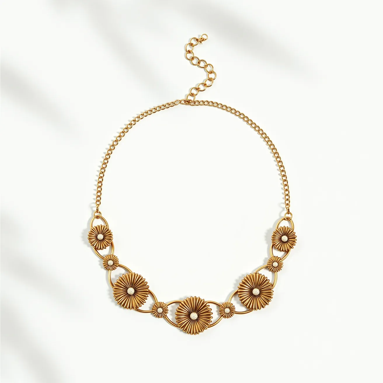 This gold flower necklace features a series of intricately designed floral motifs, each crafted from a gold-toned metal that exudes elegance and sophistication. The flowers are arranged in a symmetrical pattern, with each blossom centered around a small, round gemstone that adds a subtle sparkle, possibly suggesting a simple prong setting. The necklace includes a delicate chain that seamlessly complements the floral design, leading to an adjustable clasp with a short chain extension for versatile wearability. The combination of the gold finish and the shimmering gemstones creates a timeless piece suited for various occasions.