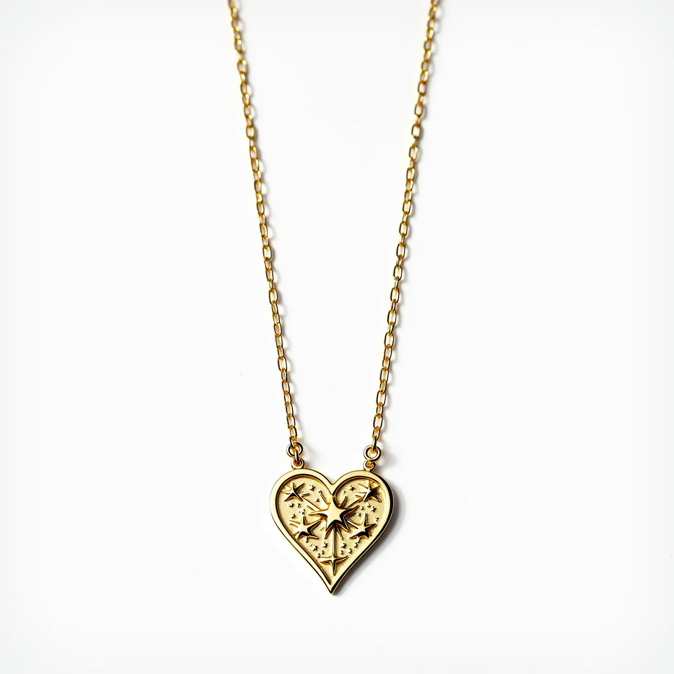 This gold heart necklace features a delicate gold chain paired with an intricately designed heart-shaped pendant. The pendant showcases an ornate pattern, possibly in the form of engraved celestial motifs, adding an artistic flair to the piece. The necklace appears to be crafted from gold, giving it a luxurious and timeless appeal. It is attached with simple yet elegant links connecting the chain to the pendant. The overall design is sophisticated, making it suitable for a wide range of occasions.