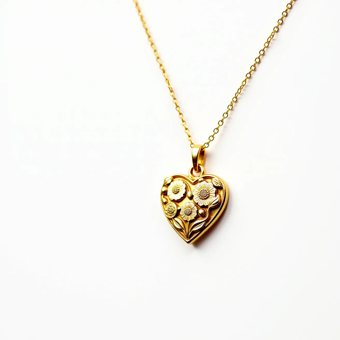 This gold heart necklace features a beautifully crafted heart-shaped pendant made from gold. The pendant is adorned with intricate floral motifs, emphasizing its elegant design. The chain is a delicate gold link style, complementing the pendant's craftsmanship. The necklace is equipped with a standard spring ring clasp, ensuring that the jewelry is securely fastened when worn. The combination of the pendant's floral embellishments and the shimmering gold chain makes this piece a timeless and versatile accessory.