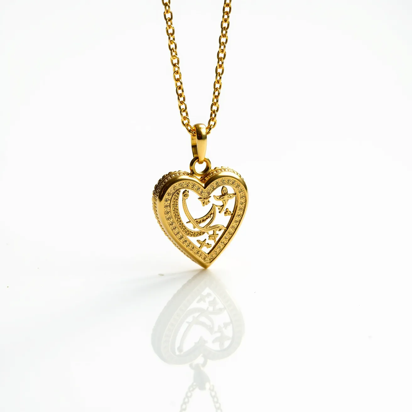 This gold heart necklace features a beautifully crafted heart-shaped pendant, intricately designed with a filigree pattern incorporating birds and stars. The pendant is framed with clear, sparkling gemstones set in a pavé style, enhancing its elegant appearance. The necklace is made of polished gold, offering a luxurious sheen. The pendant hangs from a matching gold chain, linked securely through a polished gold bail. The clasp securing the chain is a classic lobster clasp, providing both reliability and ease of use.