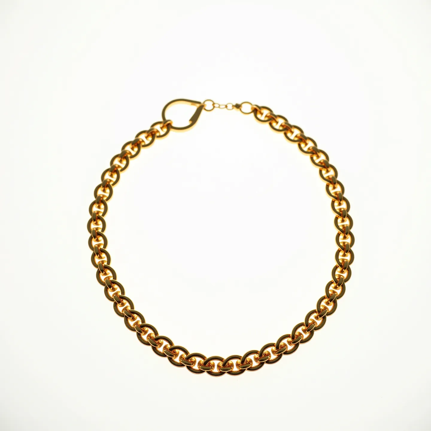 This gold link necklace features a series of interlocking round links, creating a luxurious and classic design. The necklace is crafted from a gleaming gold material, providing a rich and warm appearance. It is equipped with a heart-shaped clasp, ensuring a secure fit when worn. The simplicity and elegance of the design make it a versatile accessory suitable for various occasions. There are no gemstones or additional embellishments present on this necklace, highlighting the beauty of its gold links.