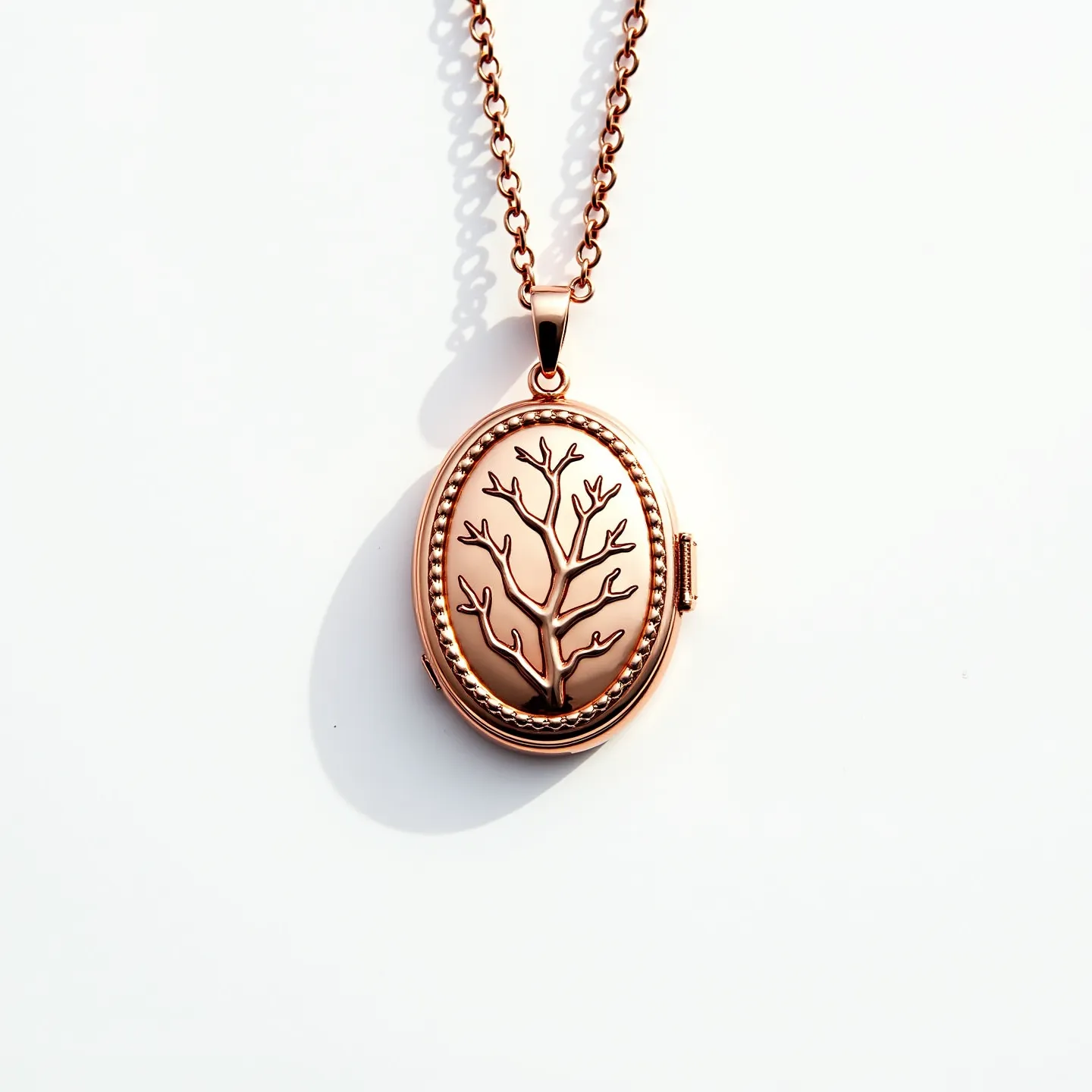 This gold locket necklace features a beautifully crafted oval pendant with a detailed tree design, bordered by a delicate beaded edge. The pendant is suspended from a chain made of interlocking links, providing a classic and elegant look. The locket is likely crafted from gold, imparting a warm and rich hue to the piece. The closure appears to be a classic locket clasp, allowing for easy opening and secure fastening. The attention to detail and the intricate design make this piece both a timeless and stylish accessory.