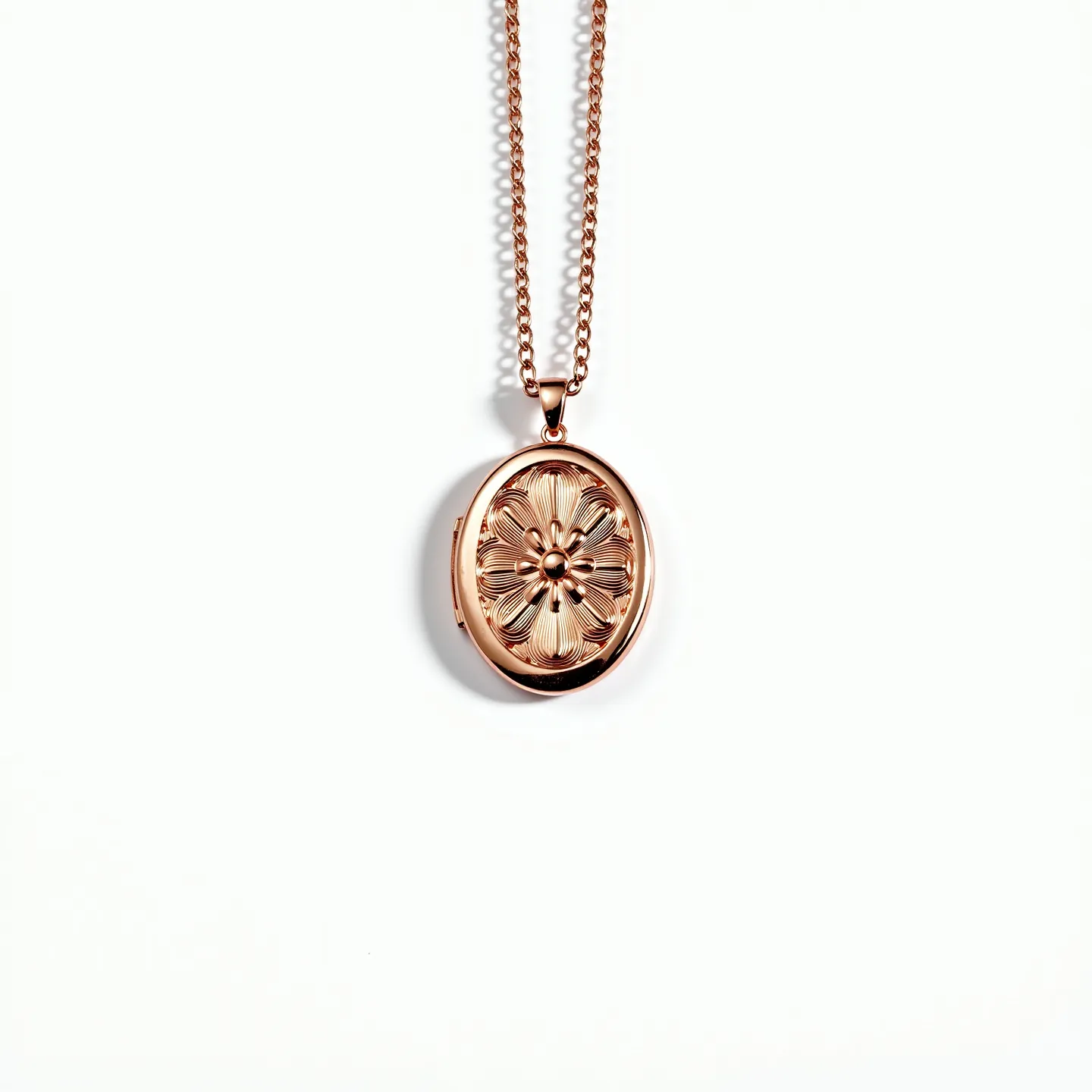 This gold locket necklace features an intricately designed oval pendant, crafted from a warm gold-tone metal. The front of the locket is adorned with a detailed floral pattern, showcasing a raised central blossom with petal-like engravings radiating outward. The necklace includes a smooth, interconnected chain that seamlessly complements the locket's design, offering both aesthetic appeal and durability. The pendant is attached to the chain with a secure bail that ensures stability and ease of wear. The overall piece combines elegance and craftsmanship, with attention to decorative elements and functional aspects.