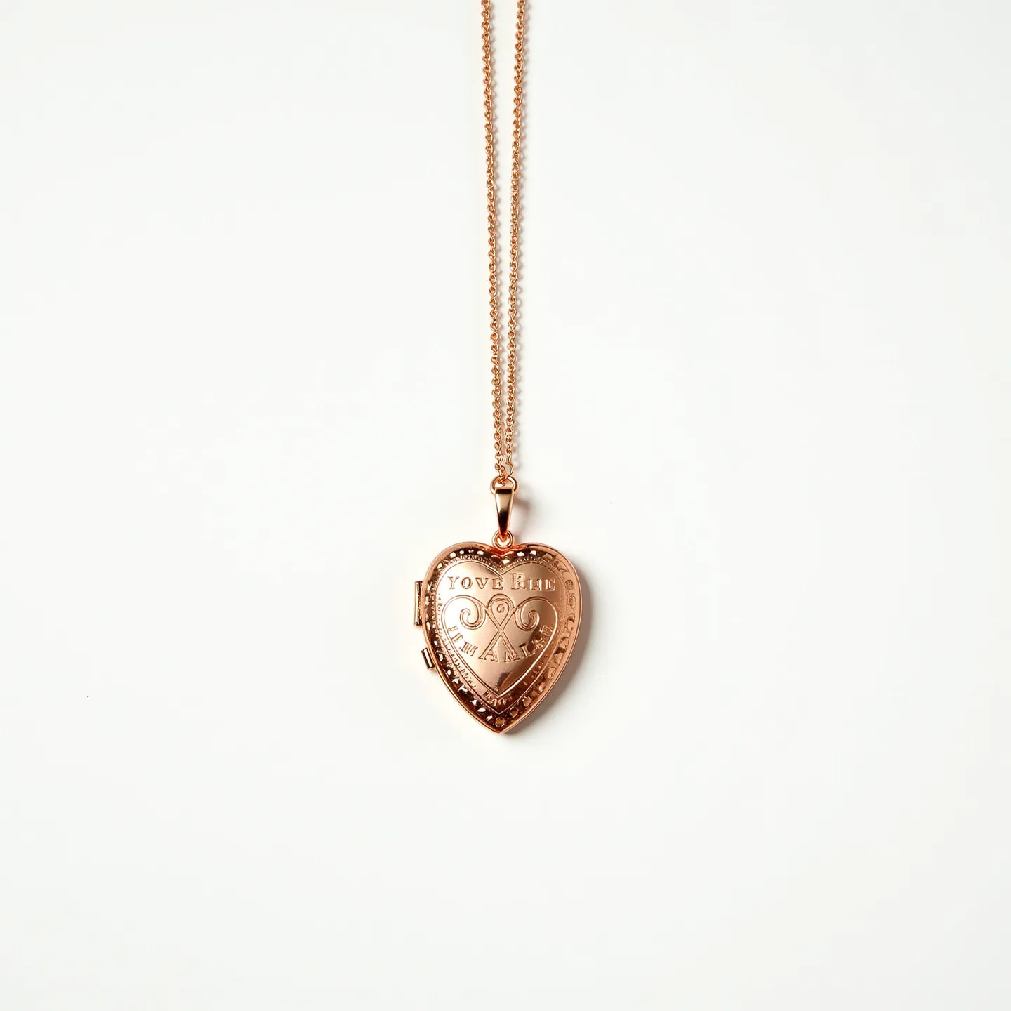 This gold locket necklace features a heart-shaped pendant crafted from gold, showcasing an intricate engraved design with the words "YOU'RE IN MY HEART." The locket’s surface reveals delicate scrollwork, adding to its ornate appearance. The pendant hangs from a fine gold chain, connected via a small gold bail that allows smooth movement and flexibility. The locket has a secure hinge on one side, suggesting it can open to hold small, cherished items or photos. The absence of visible gemstone accents provides a classic and elegant look, focusing attention on the locket’s detailed craftsmanship and personal significance.