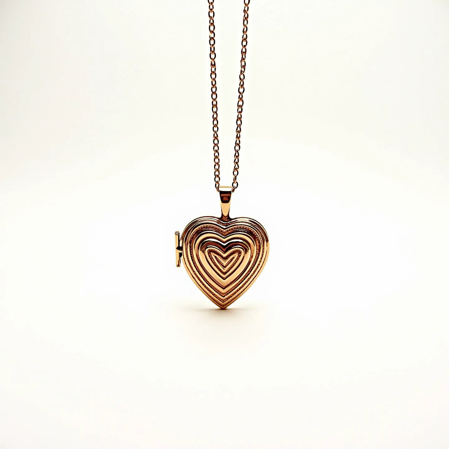 This gold locket necklace features a heart-shaped pendant with a layered design, each layer slightly indented to create a textured effect. The locket appears to be crafted from a polished gold material, giving it a luxurious shine. It is suspended from a delicate gold chain, which complements the overall elegance of the piece. The locket is secured with a subtle hinge and clasp mechanism on the side, allowing it to open and close securely. The absence of gemstones ensures the focus remains on the intricate goldwork and the meaningful shape of the pendant.