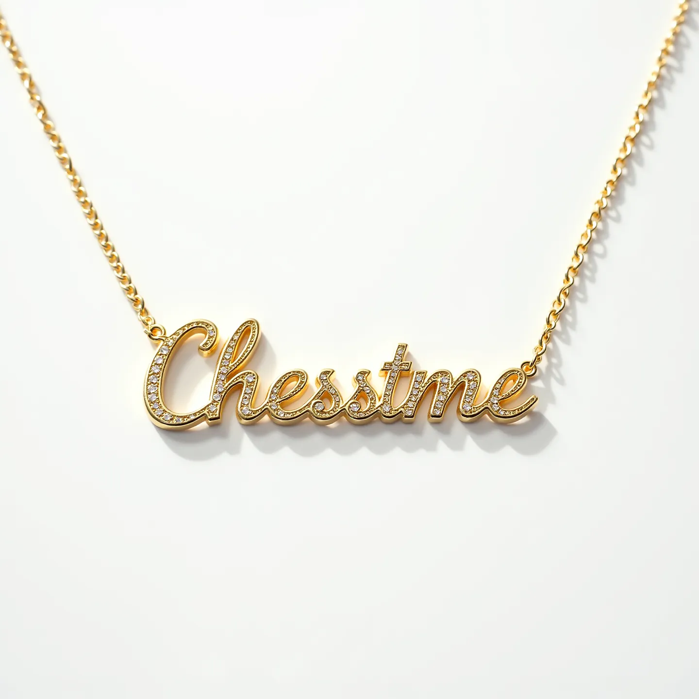 This gold name necklace features the word "Chesstime" in a stylish cursive script, crafted from a rich gold material. The scripted letters are adorned with small, round-cut gems, likely diamonds, set in a pavé style that accentuates the lettering with a sparkling effect. The attachment is seamlessly integrated into a delicate gold chain, providing an elegant and cohesive look. The chain is equipped with a standard adjustable clasp, allowing for easy wear and removal while ensuring the necklace remains secure.