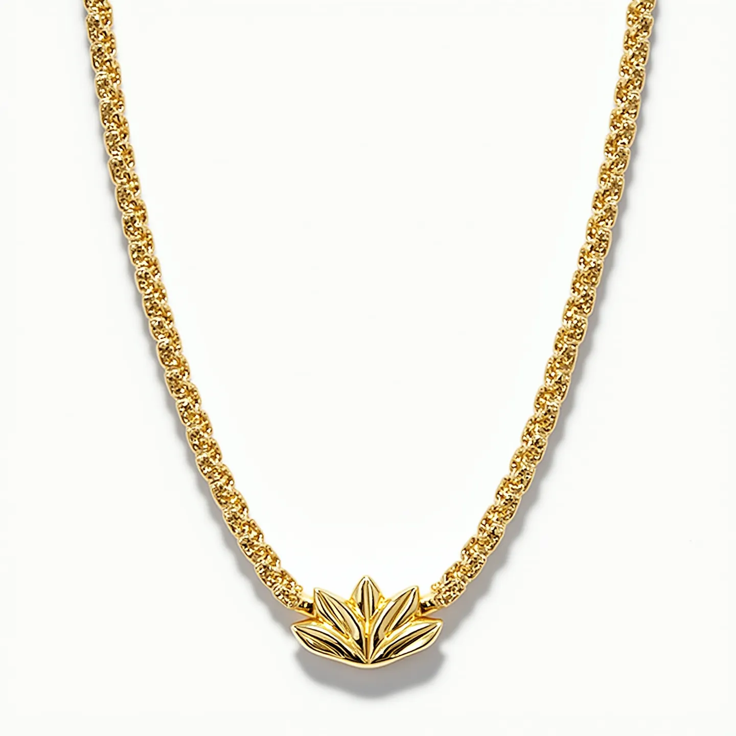 This gold necklace features a delicate and intricately woven chain, showcasing the luxurious sheen typical of high-quality gold. At the center is an elegantly crafted lotus-shaped pendant that highlights the necklace's design. No stones or gems adorn this piece, emphasizing the pure gold craftsmanship. The necklace likely employs a secure clasp, such as a lobster claw or spring ring, common in jewelry of this type for ease of wear. The combination of the classic chain and unique central motif creates a harmonious and refined accessory.