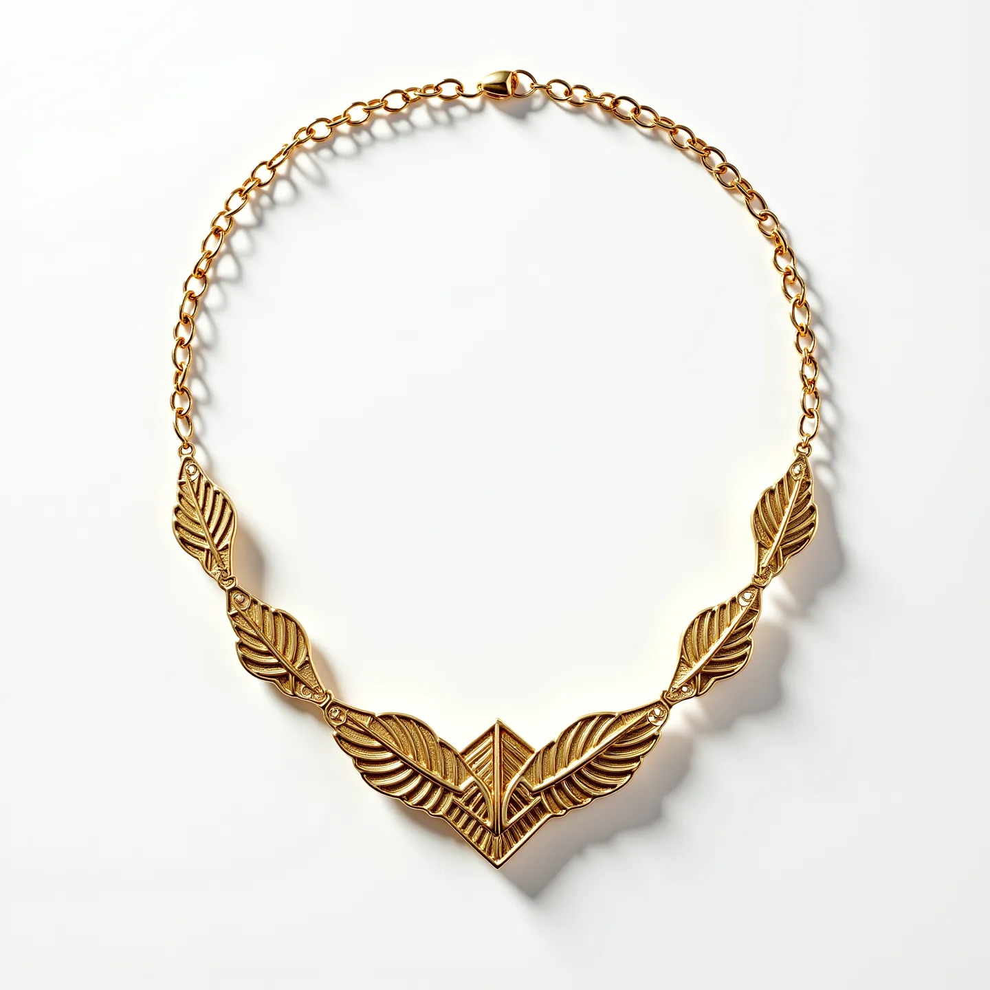 This gold necklace features a series of intricately designed leaf-like elements arranged symmetrically, giving it an elegant, nature-inspired appearance. Each leaf is meticulously crafted, providing texture and dimensionality to the overall design. At the center, the design converges into a V-shaped motif that serves as a focal point. A subtle, polished finish underscores the richness of the gold material, elevating its overall allure. The necklace is equipped with a secure lobster clasp, ensuring ease of wear while maintaining its stylish aesthetic.