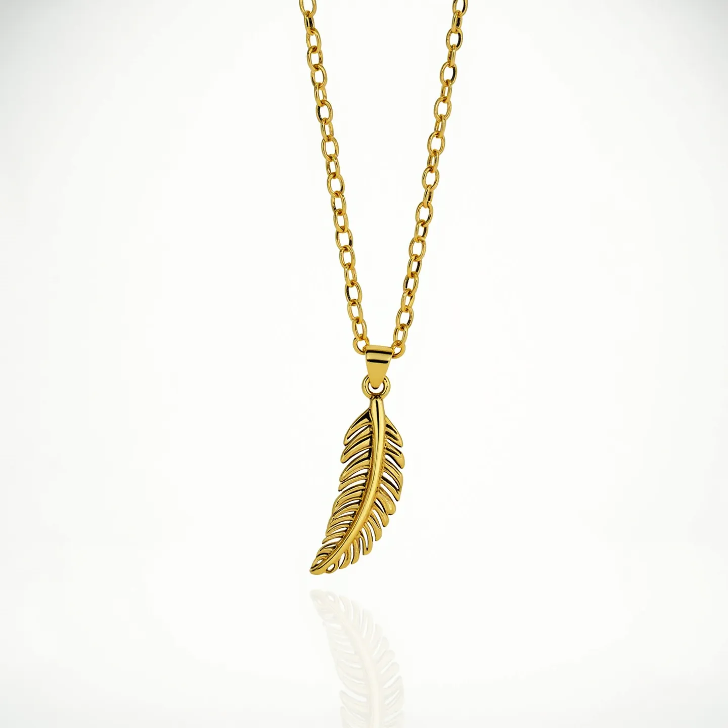 This gold necklace features a delicate chain composed of uniformly sized oval links, giving it a classic appearance. The centerpiece of the necklace is a beautifully crafted feather-shaped pendant, which showcases intricate detailing that enhances its elegance and complements the polished gold finish. The pendant hangs from a small, subtle bail that seamlessly integrates with the chain. The necklace likely includes a standard clasp mechanism, though it is not visible in the image, providing secure attachment and ease of wear. Overall, the necklace exemplifies a harmonious blend of refined simplicity and artistic design.