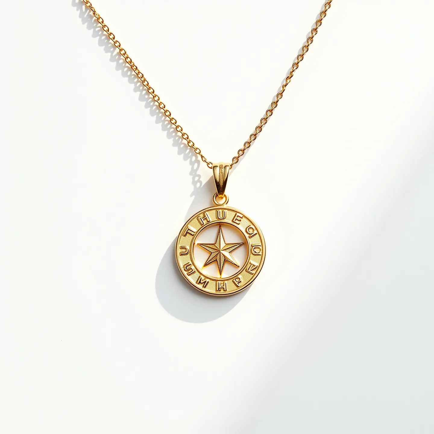 This gold necklace features a delicate chain that supports a circular pendant. The pendant showcases a star emblem at its center, encircled by an inscribed border. The craftsmanship highlights a smooth gold finish, enhancing its elegance. The pendant attachment is a simple bail design, allowing fluidity in movement while maintaining secure placement on the chain. No gemstones are present, accentuating the refined simplicity of gold as the primary material, and the necklace is secured with a standard lobster clasp.