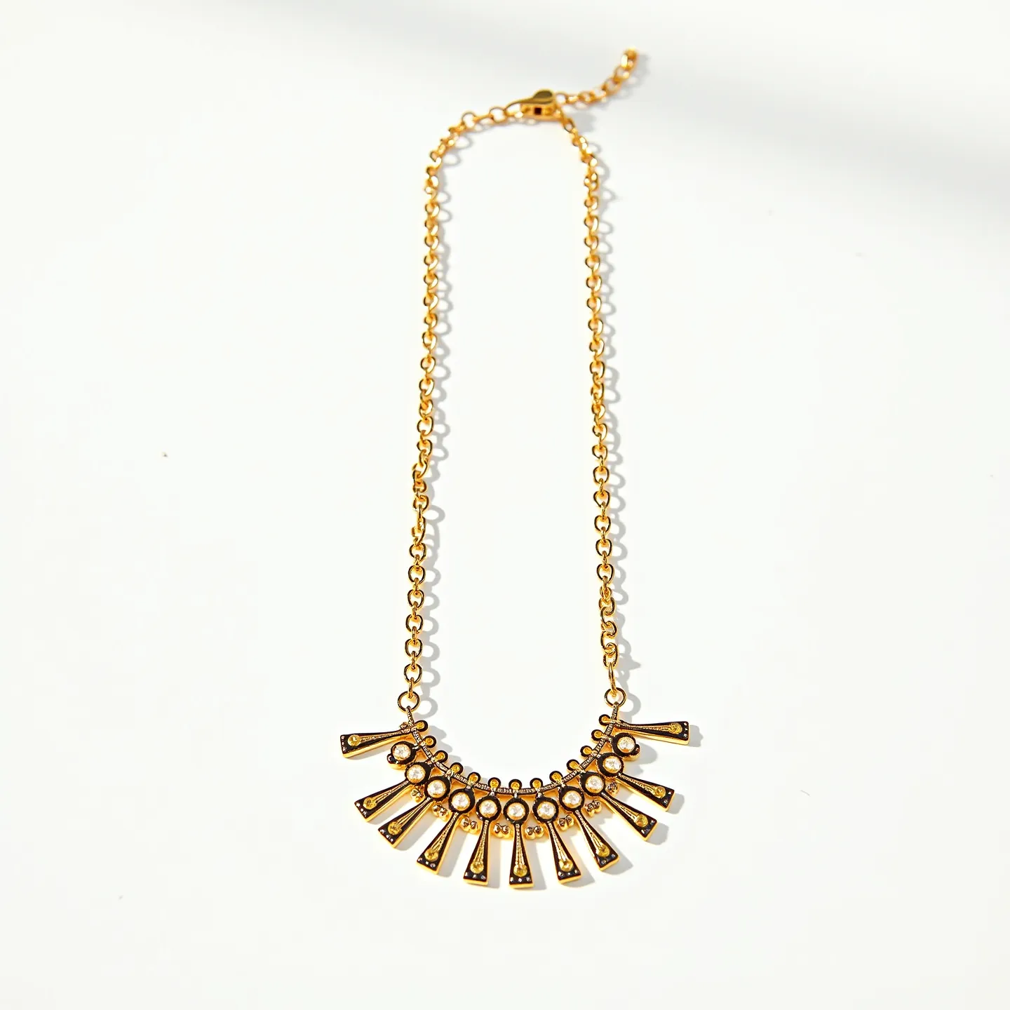 This gold necklace features a unique and intricate design, incorporating a series of small, round gems set into the decorative pendant section of the piece. The gems appear to be set in simple bezel settings, which seamlessly integrate with the overall gold framework of the necklace. The pendant showcases an array of elongated, stylized spikes that radiate from a central axis, each adorned with a single gem accentuating their tips. The gold chain itself is composed of small, interlocking links that are both sturdy and elegant. Additionally, the necklace is equipped with a lobster clasp, ensuring a secure and easy attachment.