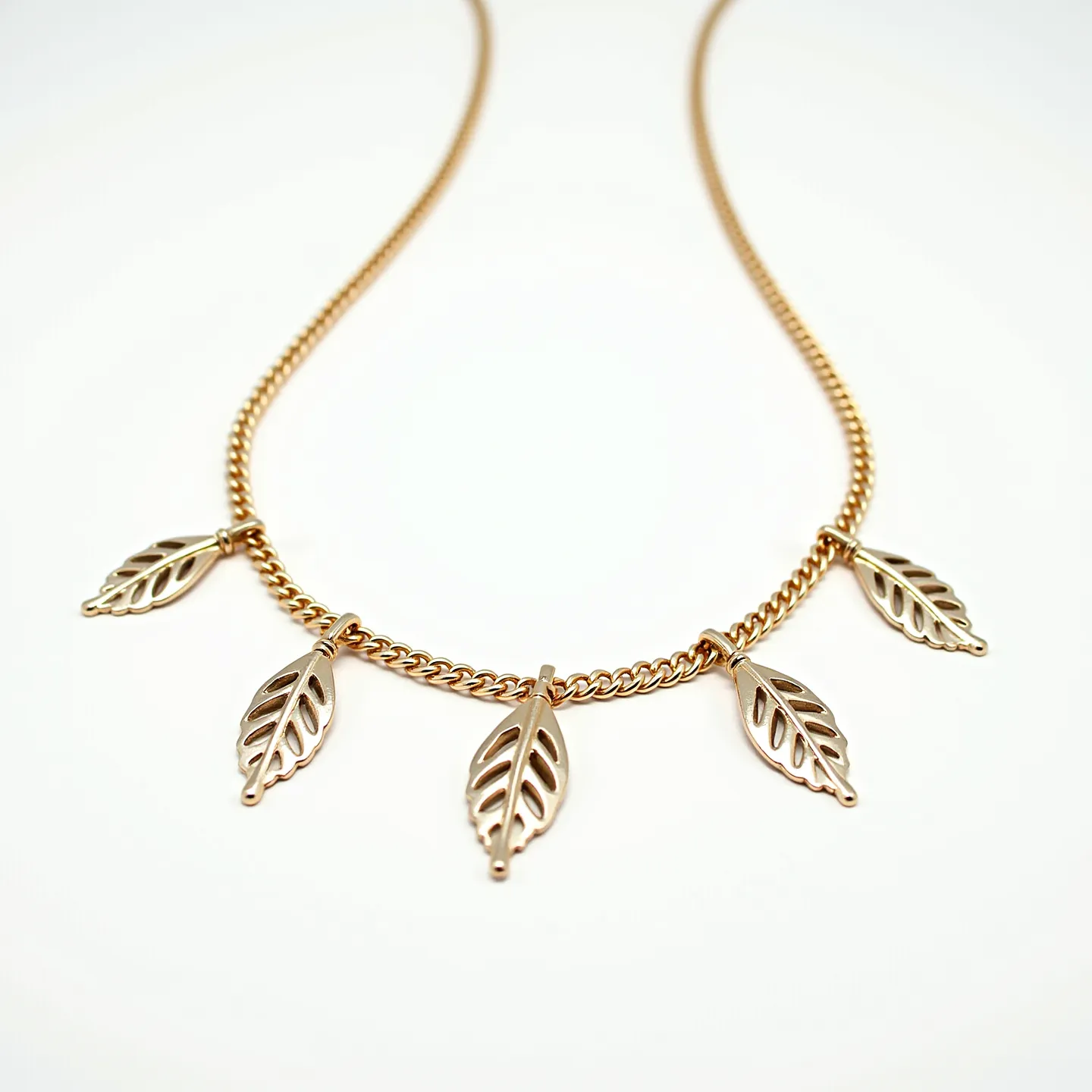 This gold necklace features a delicate chain adorned with five intricate leaf-shaped pendants. Each leaf is artfully crafted, emphasizing symmetrical cutouts that add a touch of elegance to the design. The leaves are evenly spaced along the chain, creating a balanced and aesthetically pleasing appearance. The necklace is composed entirely of gold, highlighting a warm, luxurious glow. It is likely fastened with a simple clasp that ensures both security and ease of wear. The overall design combines natural elements with refined craftsmanship, making it a versatile accessory.