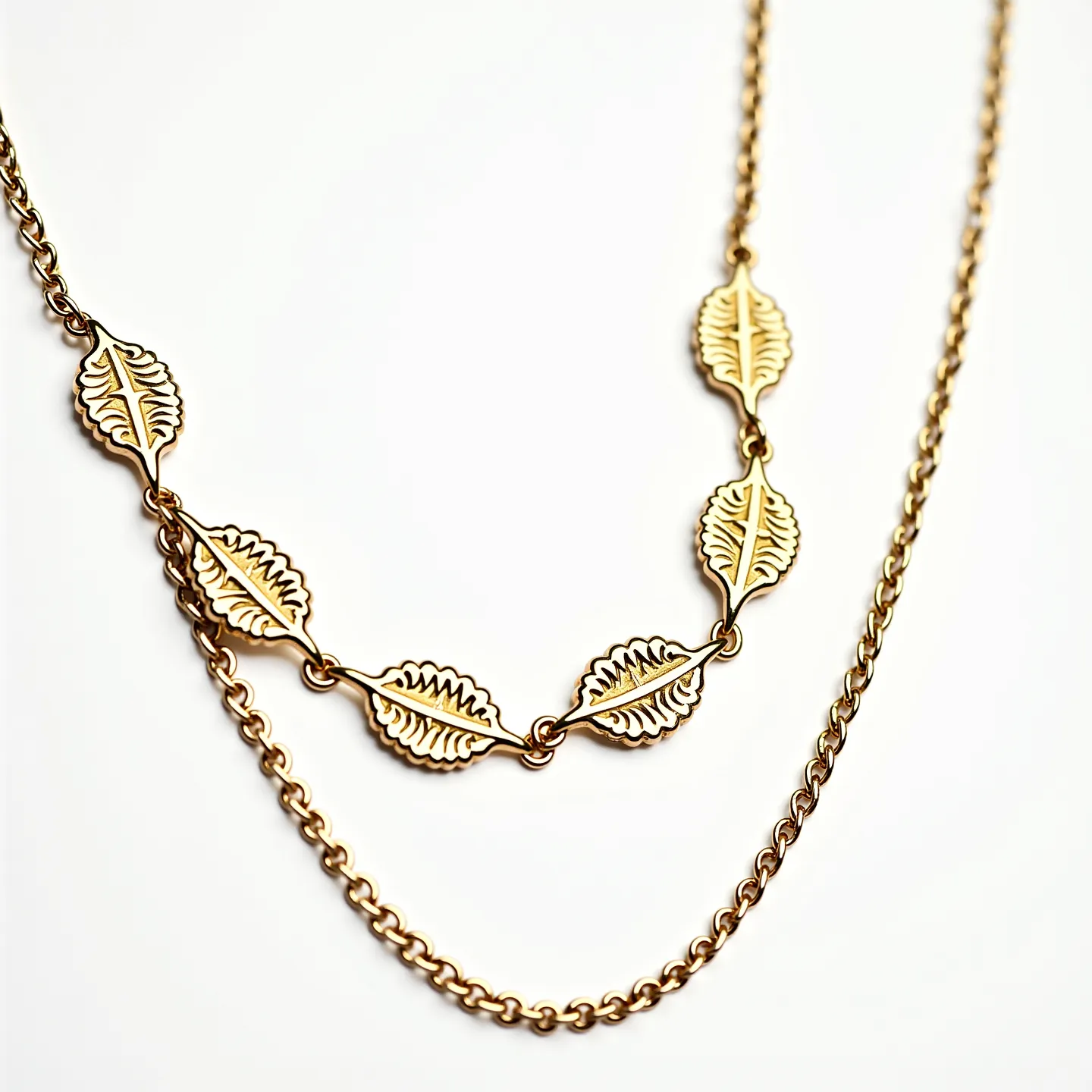 This gold necklace features a delicate design with a series of intricately crafted leaf-shaped links connected in succession, giving it a nature-inspired, elegant appearance. The leaves are artfully detailed, embossed with veins that enhance their realistic look, and are likely made of polished gold or gold-plated material, adding to their gleaming finish. The necklace also includes a simple chain link section, complementing the leafy elements. It appears to have a standard clasp attachment, providing secure closure and wearability. The combination of polished metalwork and natural motifs offers a harmonious blend of style and craftsmanship.