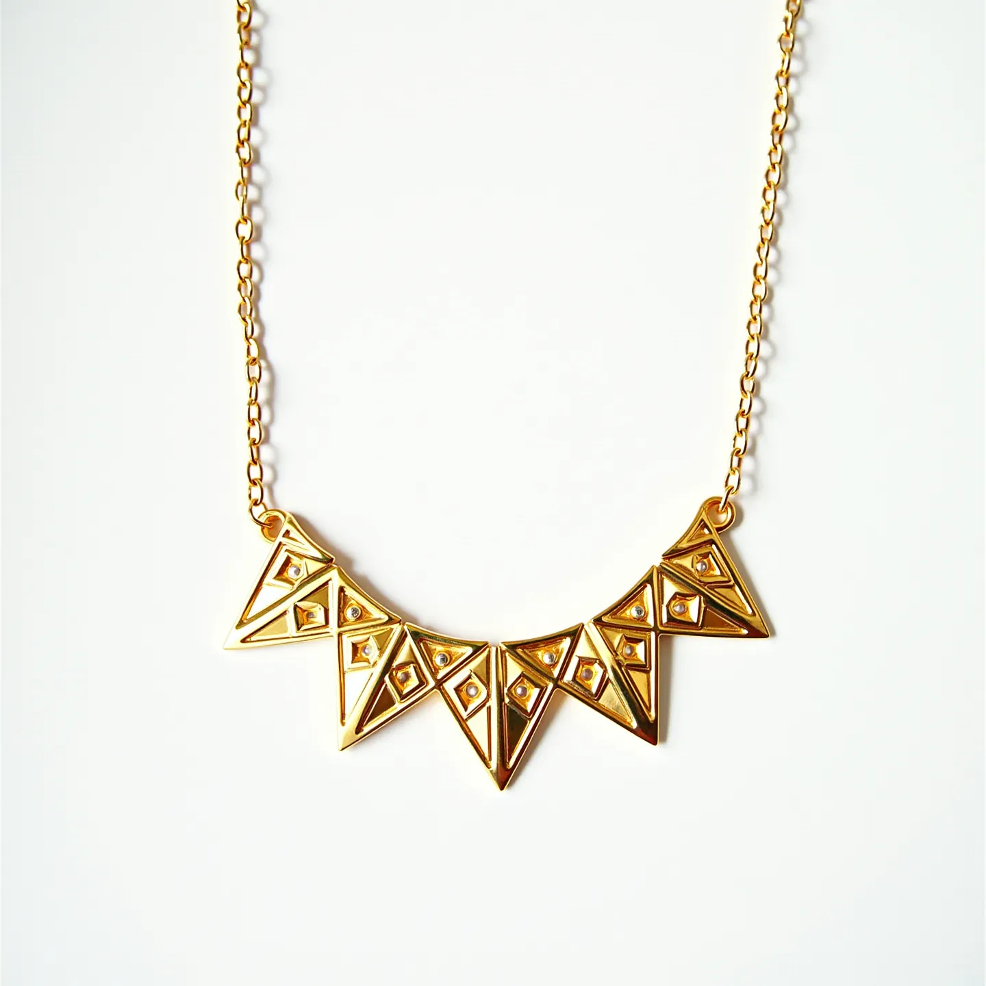 This gold necklace features a series of geometric, triangular pendants with an intricate design that includes cut-out diamond shapes in each section. Each triangle appears to be crafted from polished gold, giving the necklace a luxe, reflective finish. The triangles are connected to a fine gold chain, which adds elegance and continuity to the piece. While there are no prominent gemstones, the detailed craftsmanship suggests a focus on the geometric aesthetic. The necklace likely includes a simple clasp at the back, typical of chain designs, ensuring it can be securely fastened. Overall, the piece presents a modern yet timeless design.