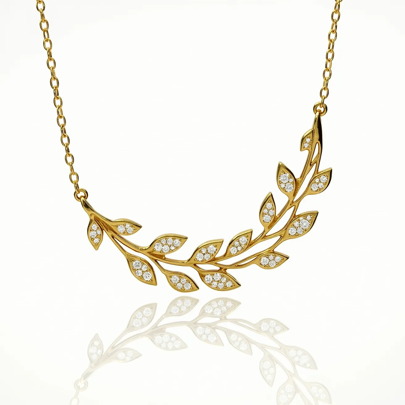 This gold necklace features an elegant design resembling a leafy branch, crafted from polished gold. Each leaf is accented with small, round-cut white gemstones, likely diamonds, set in a pave style to enhance their brilliance and create a seamless sparkle across the piece. The necklace is attached to a fine gold chain, adding sophistication to its delicate appearance. The clasp or attachment at the end of the chain is not prominently displayed but is likely designed to complement the overall aesthetic while ensuring secure wear.