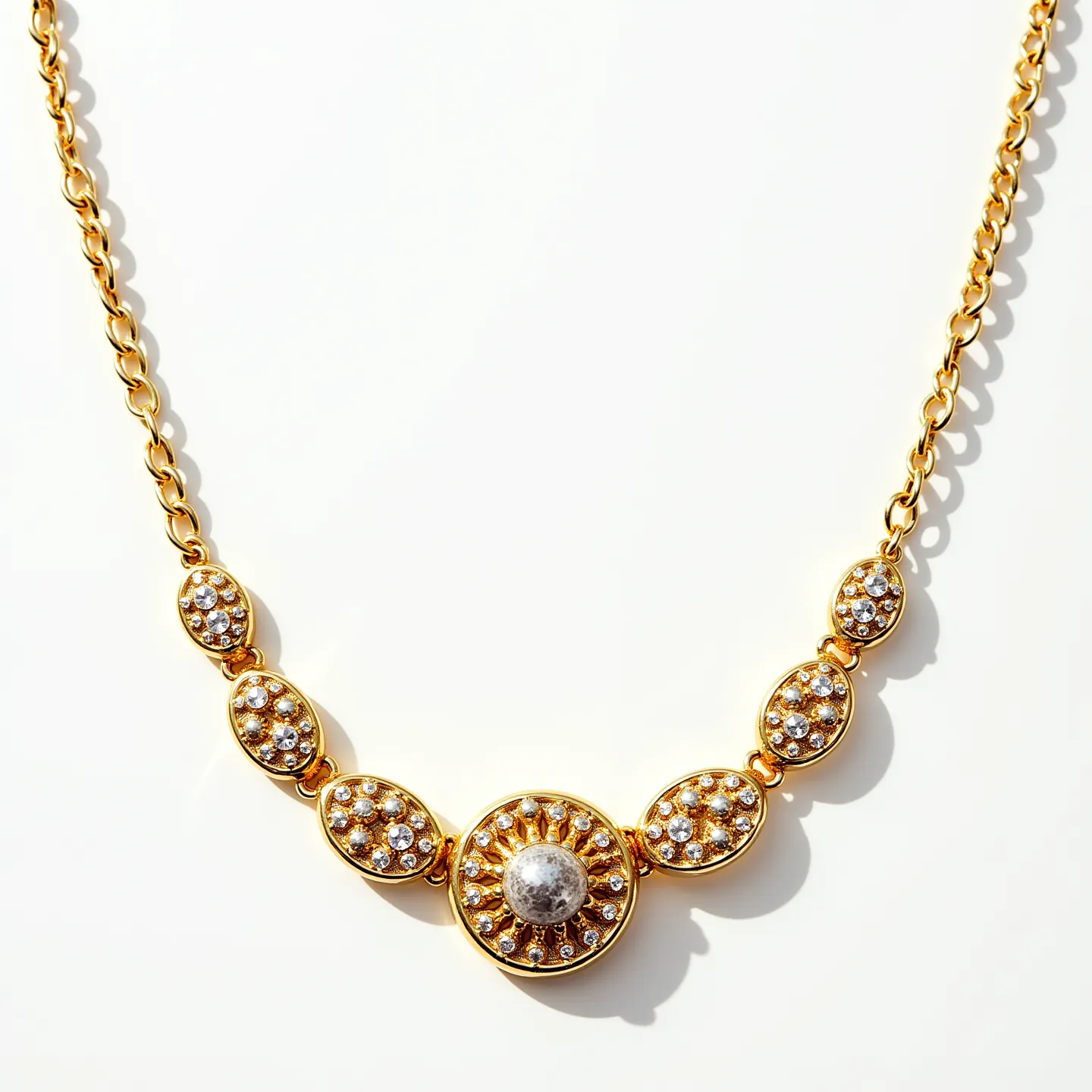 This gold necklace showcases an elegant design crafted from lustrous gold, featuring detailed sections adorned with small, round-cut gemstones set in a pavé style, enhancing the necklace's brilliance. The central piece boasts a larger, spherical gem with a textured, sunburst-like setting that adds a sophisticated focal point to the piece. The necklace is connected by a chain of polished gold links, offering flexibility and comfort for the wearer. It is likely secured with a conventional clasp, providing both security and ease of wear. This necklace epitomizes a blend of classic and contemporary styles, making it a versatile adornment for various occasions.