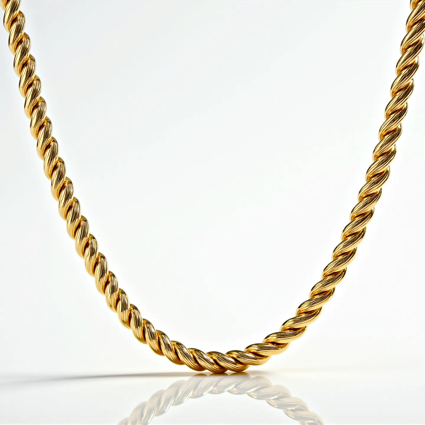 This gold rope necklace features a beautifully twisted design that gives it a classic and elegant appearance. The gold material adds a rich, warm glow, enhancing its sophisticated appeal. There are no visible gemstones or ornamental stones embedded in the necklace, maintaining its minimalist charm. The necklace likely uses a standard clasp mechanism, though the specifics are not visible in the image. The craftsmanship highlights the luxury and timelessness often associated with rope-style jewelry pieces.