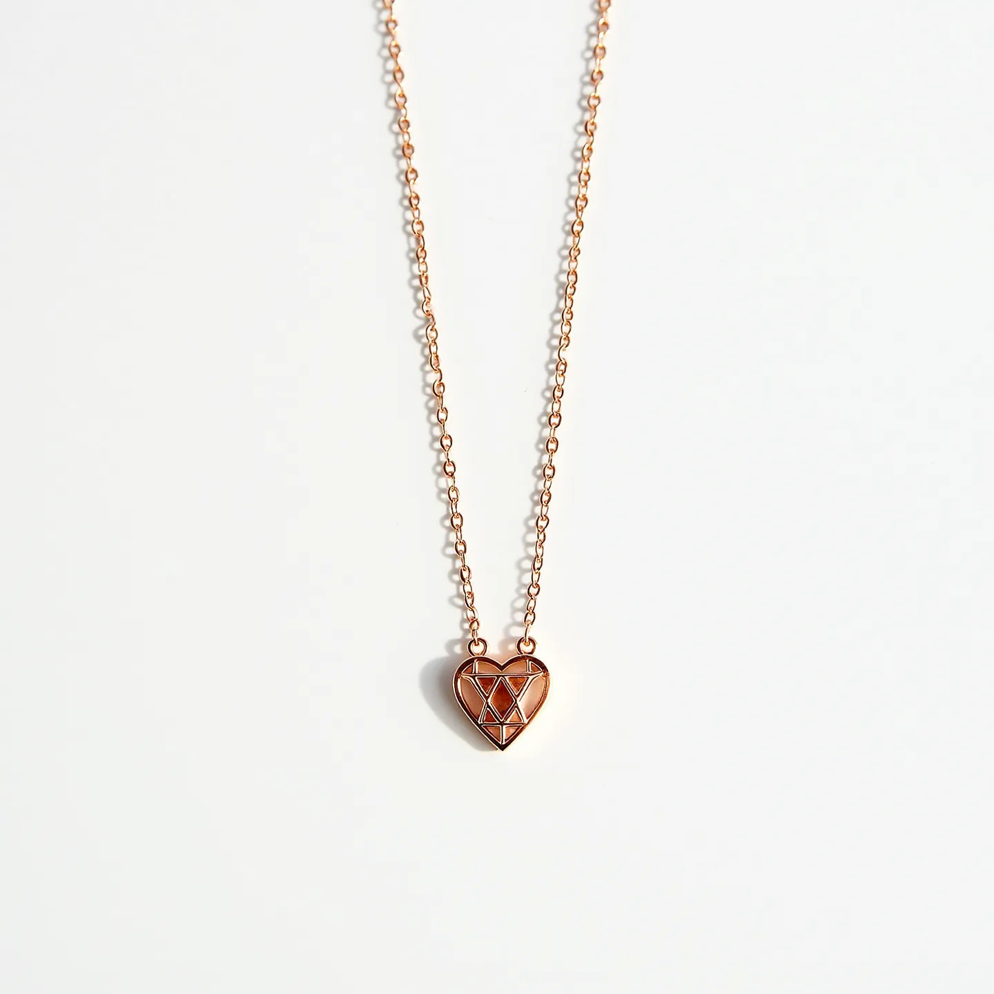 This heart chain necklace features a delicate rose gold chain, exhibiting interlinked circular links that provide a subtle elegance. The centerpiece is a heart-shaped pendant crafted from a similar rose gold material, with a unique geometric pattern etched into its surface, resembling the facets of a gemstone. The clasp, though not shown in detail, is likely to be a standard lobster or spring ring clasp, matching the chain's refined aesthetic and ensuring a secure fit. The overall design combines modern geometric elements with classic romantic motifs, making it a versatile accessory for various occasions.