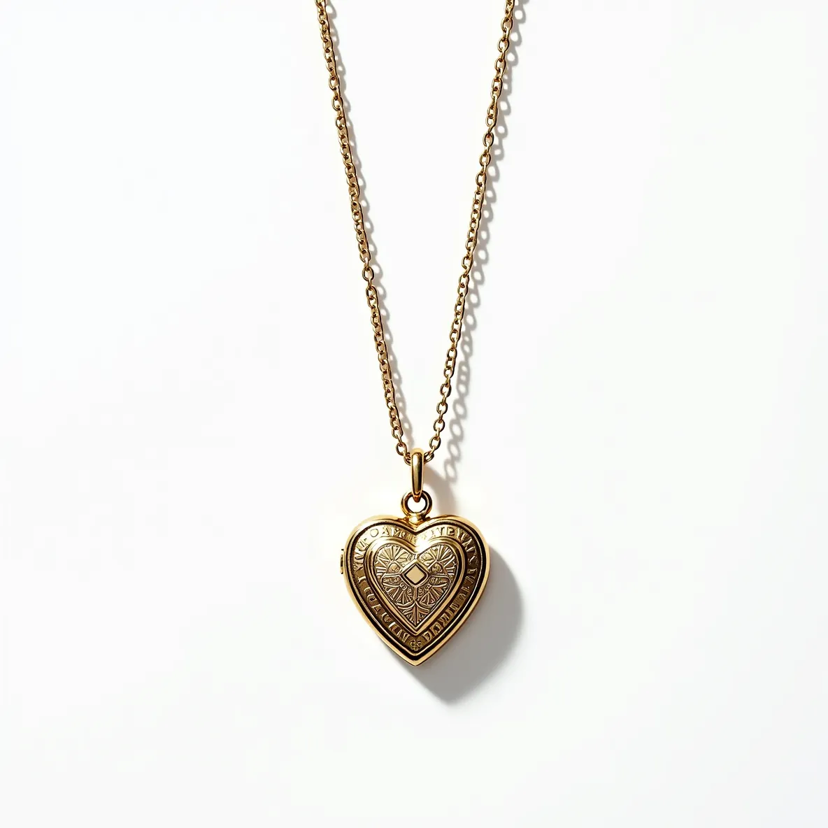 This heart locket is crafted from gold-toned metal, featuring an intricate engraved design on its surface that adds a touch of elegance. The center of the heart displays a detailed motif, enhancing its aesthetic appeal. It is attached to a delicate chain with a small, simple bail, providing a seamless and classic connection. The chain is likely made of a coordinating gold-toned material, complementing the locket's design. The overall appearance exudes a timeless and romantic charm.