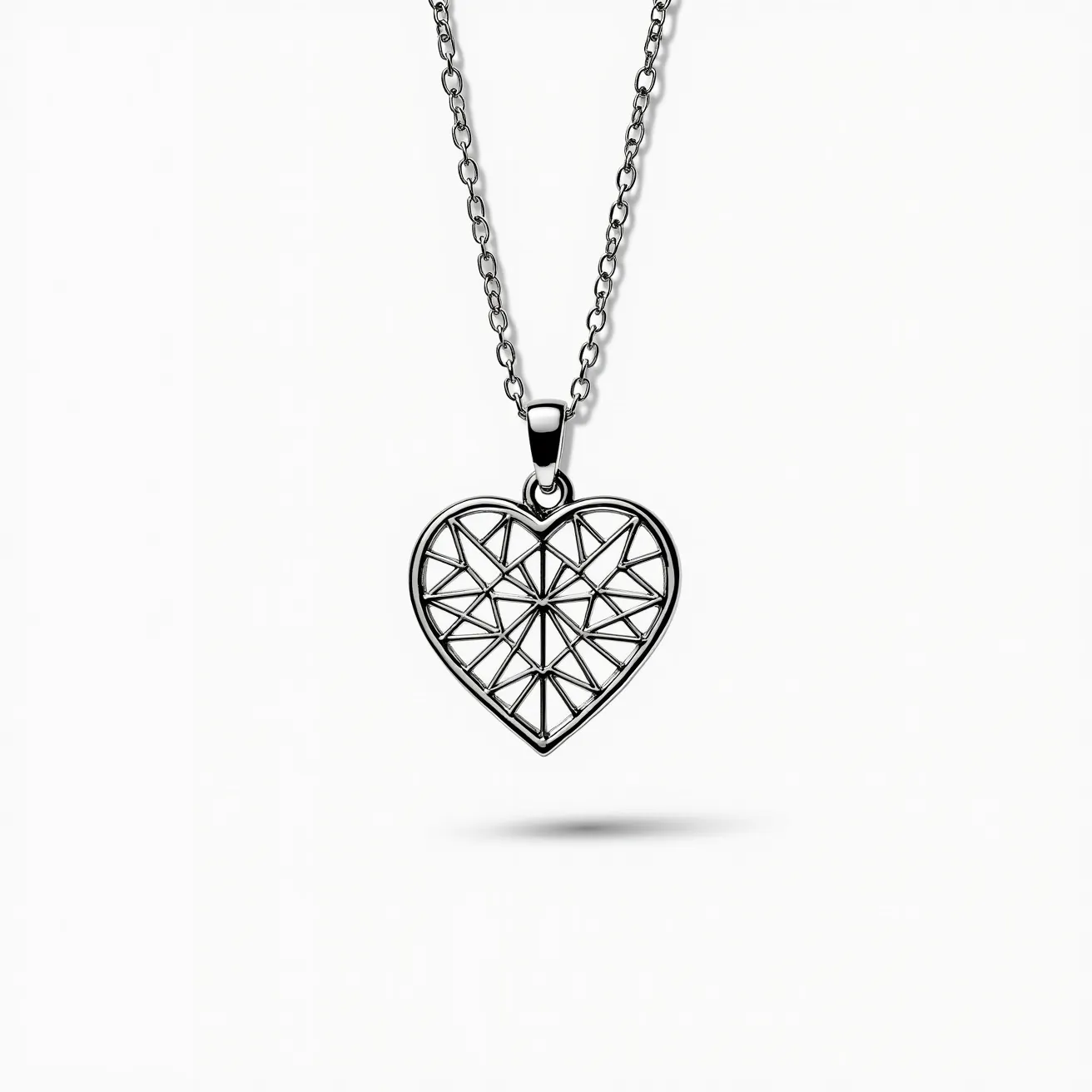 This heart necklace features an intricately designed pendant, which appears to be crafted from a polished metal, likely silver or stainless steel, given its metallic sheen. The heart-shaped pendant is designed with a geometric pattern of triangular shapes, forming an artistic and modern lattice effect. The necklace is secured with a simple chain that complements the pendant's style, connected through a small loop at the top of the heart. It likely employs a standard clasp, typical of chain necklaces, though not visible here, ensuring ease of wear. The overall design combines a sense of elegance with a contemporary touch, making it a versatile accessory.