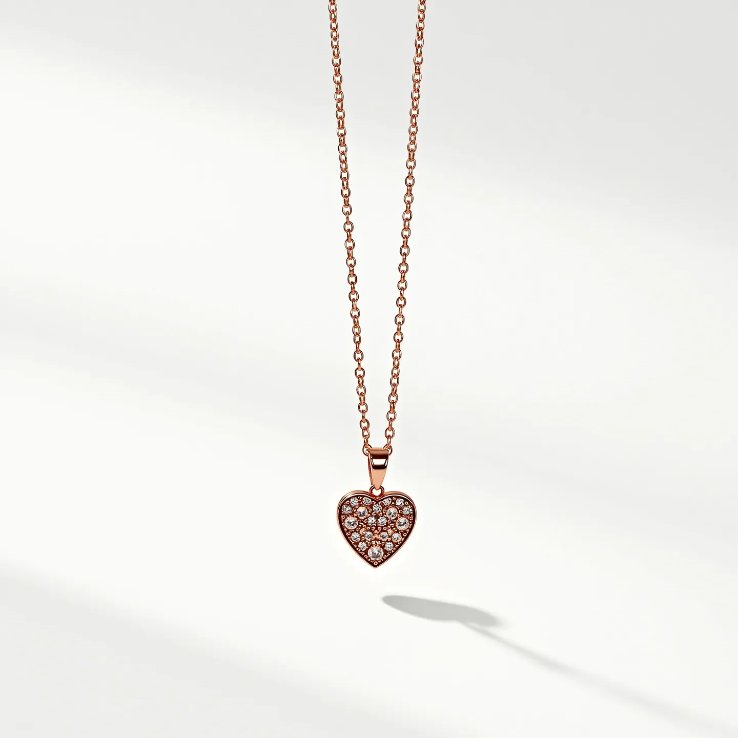 This heart necklace features a delicate chain made of rose gold, which gives it a warm and elegant appearance. The pendant is a heart shape, also crafted in rose gold, and is adorned with numerous small, round-cut diamonds. These diamonds are intricately set in a pavé style, adding a luxurious sparkle to the piece. The necklace is completed with a simple yet secure clasp, ensuring it can be worn with ease and confidence. The overall design offers a balance of simplicity and elegance, making it suitable for various occasions.