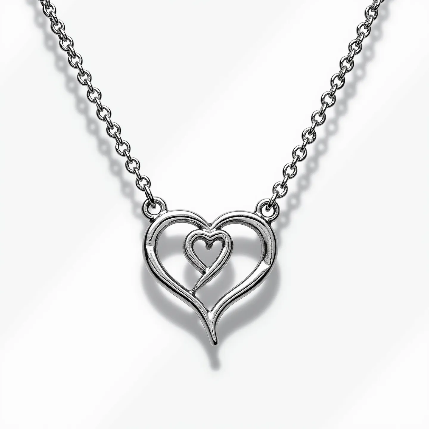 This infinity heart necklace features a polished metallic structure, likely made of silver or a silver-toned alloy, forming an intertwining design that elegantly combines an infinity symbol with a heart shape. The design is minimalistic and does not incorporate any gemstones or stones. The necklace is attached to a fine chain with small, circular links providing a delicate and refined look. The clasp is not visible in the design, suggesting it might be a simple and classic type to complement the overall aesthetic.