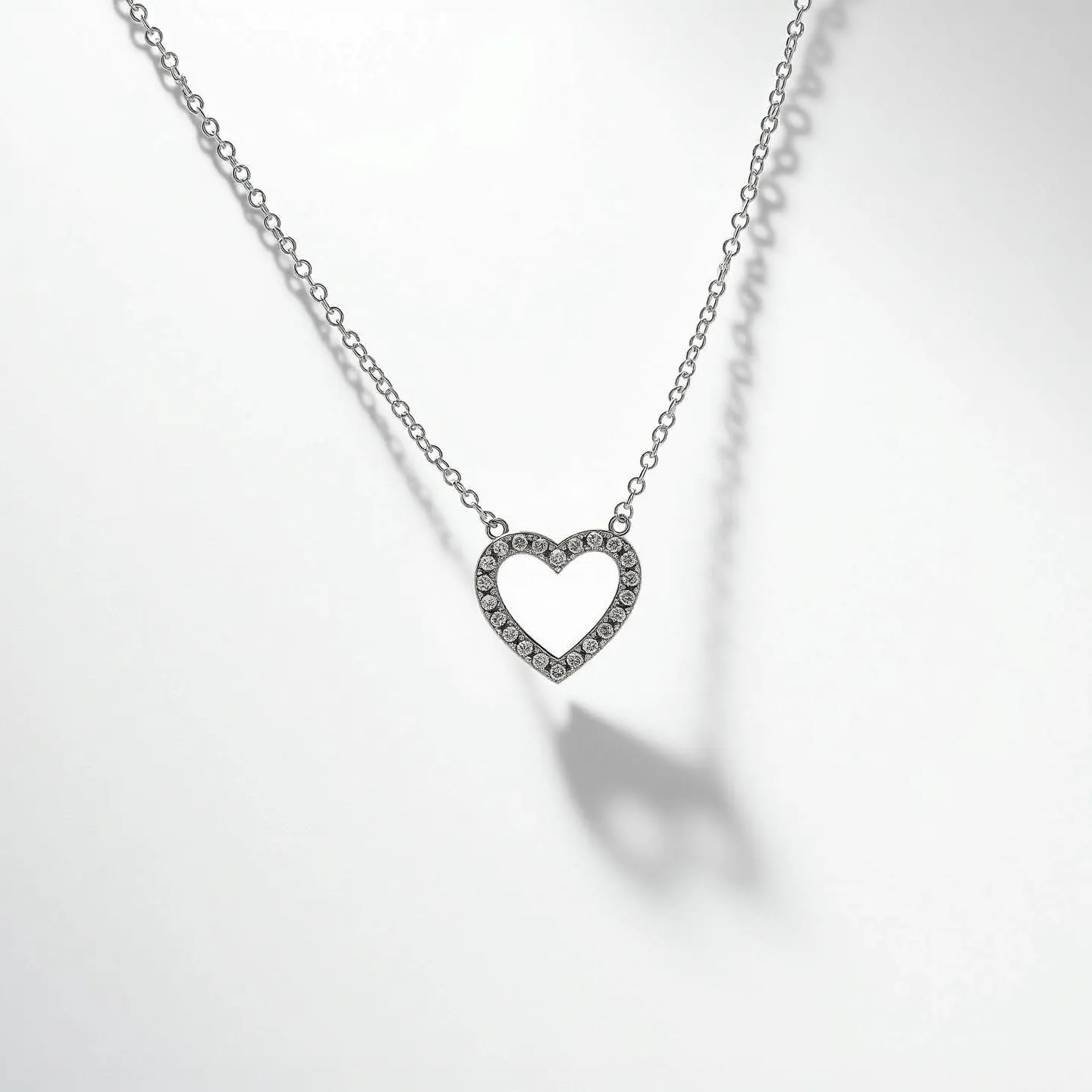 This infinity heart necklace features a delicately crafted heart-shaped pendant encrusted with an arrangement of round-cut gems, likely diamonds, set in a pavé style. The shimmering stones are nestled closely together, enhancing the sparkle across the heart's outline. The pendant is suspended from a fine, elegant chain that likely utilizes a lobster clasp for secure fastening. The materials used for the necklace appear to be a combination of precious metal, possibly white gold or platinum, complementing the brilliance of the stones and the chain's understated sheen.