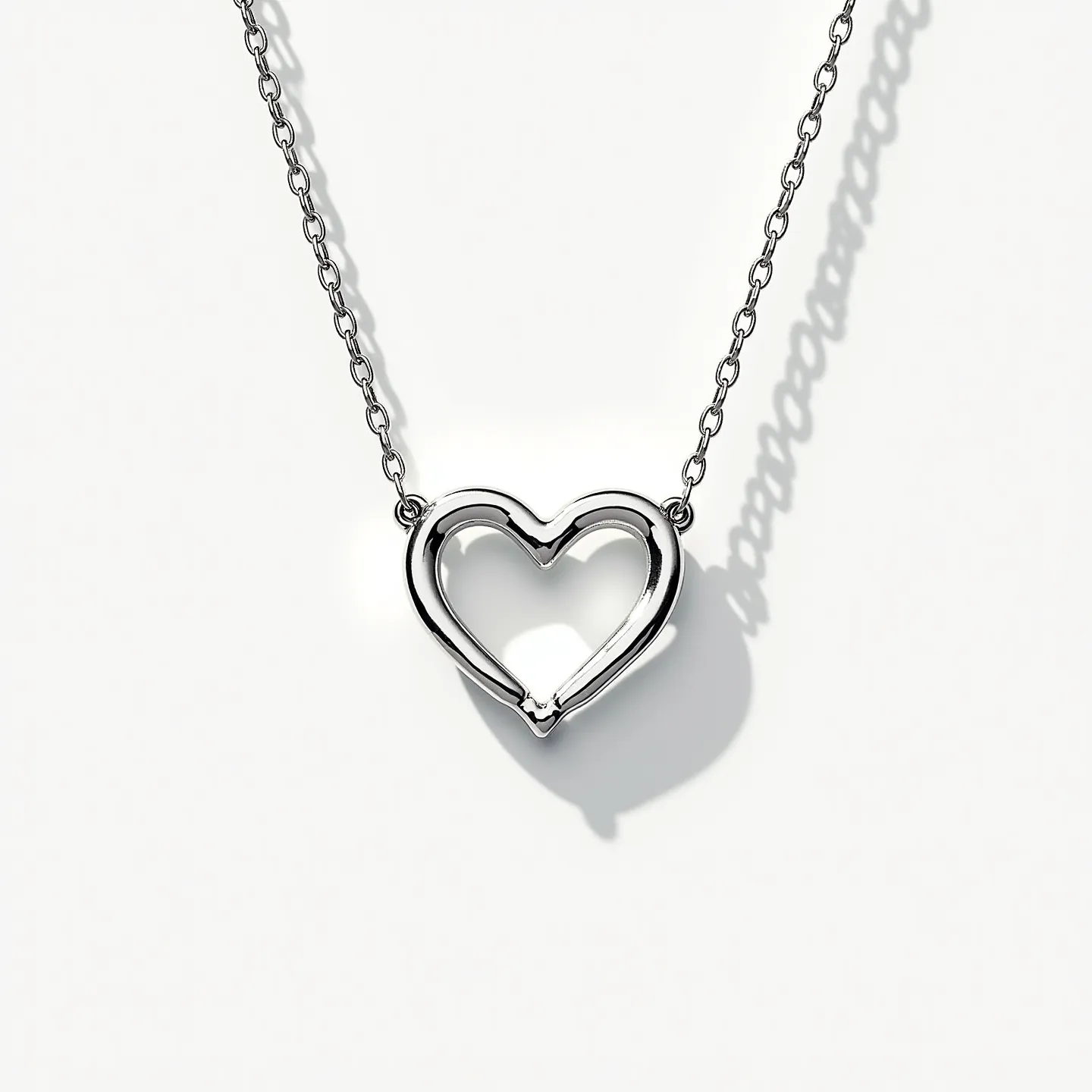 This infinity heart necklace features a sleek, metallic design, seemingly crafted from polished silver or a similar shiny metal that offers a smooth, reflective surface. The pendant elegantly forms an infinity symbol intertwined with a heart, creating a modern take on classic symbolism. It is suspended on a delicate chain, and the pendant connects seamlessly with the chain through subtle loops. The chain appears to be a simple, fine link design, complementing the pendant’s fluid shape. The necklace is secured with a conventional clasp that ensures a tidy closure.