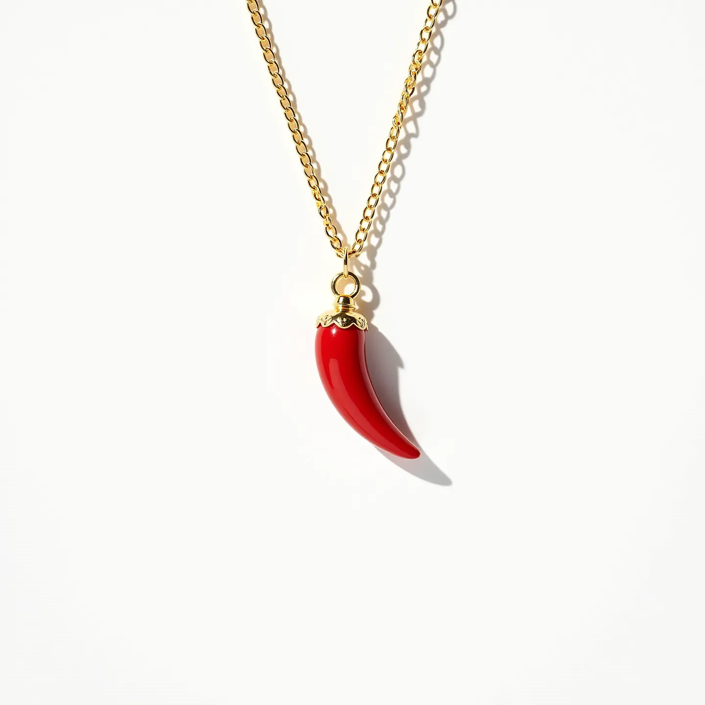 This Italian pepper necklace features a delicate gold-toned chain that supports a vivid red pepper-shaped pendant. The pendant appears to be crafted from a glossy material, possibly enamel or glass, and is mounted with a decorative gold-toned cap that attaches it to the chain. The chain’s links are uniform in size, suggesting a consistent design throughout. The pendant is not adorned with any additional gems or stones. The necklace is completed with a simple clasp for easy attachment and removal.