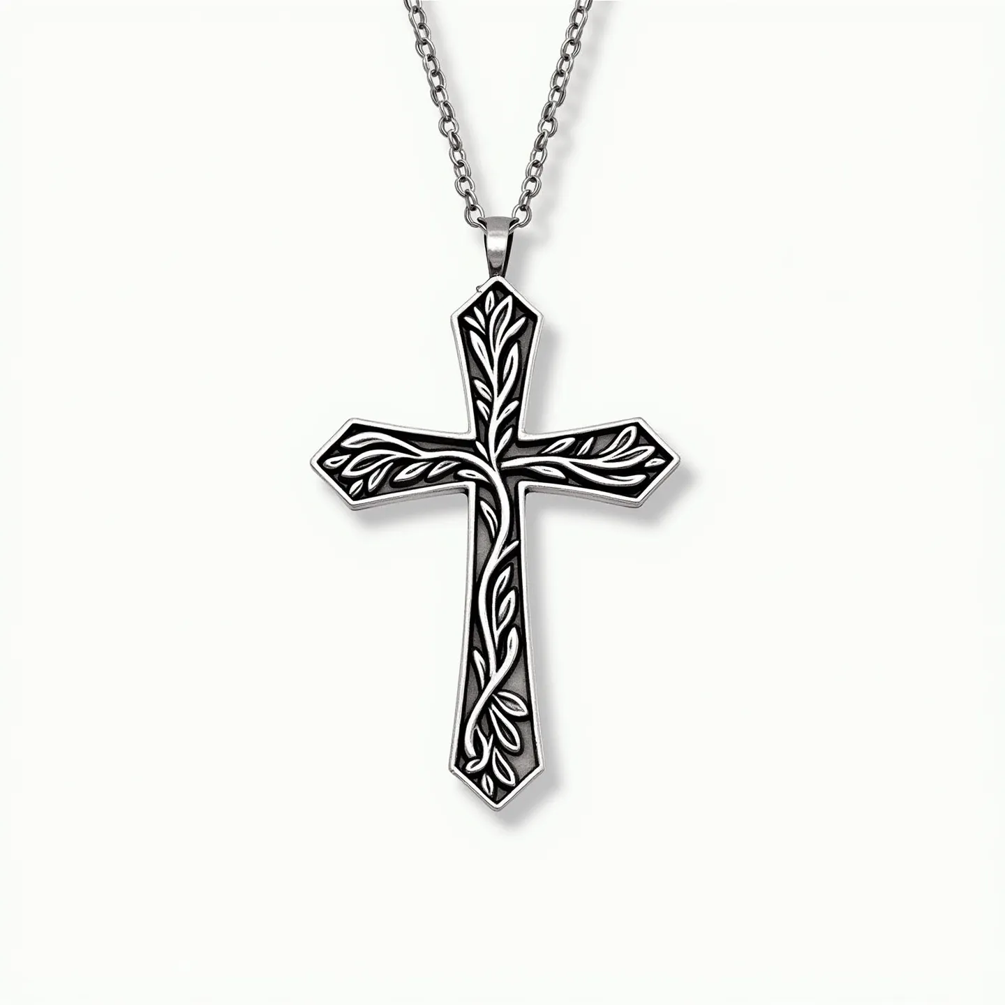 This kids cross necklace features a metal chain and a cross pendant intricately designed with vine-like engravings, suggesting craftsmanship focused on intricate detailing. The cross appears to be made of a silver-toned metal, giving it a polished and refined finish. The pendant is attached to the chain through a simple bail that seamlessly combines functionality and style. There are no visible gemstones or elaborate settings on the cross, highlighting the emphasis on the engraved artistry of the piece. The chain itself is a classic, fine-link design, allowing for a subtle elegance that complements the pendant.