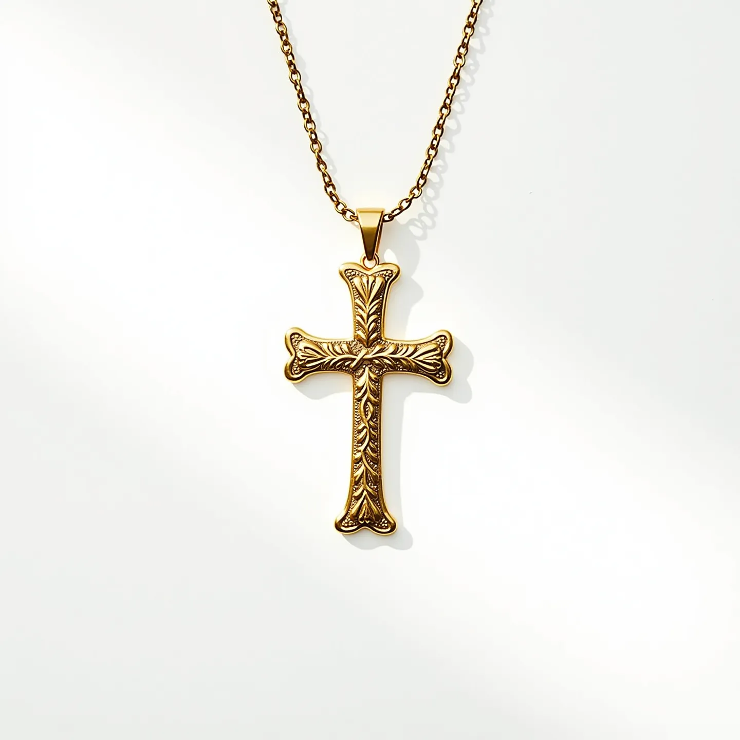 This kids cross necklace features a beautifully detailed cross pendant made of a gold-toned metal, showcasing intricate engraved patterns that give it an antique or vintage appearance. The cross is attached to a simple yet elegant chain that matches the pendant's material, likely made of the same gold-toned metal for a cohesive look. The metal is polished, providing a shiny, reflective surface that enhances its decorative design. The chain is delicate yet sturdy, suitable for a child, and includes a standard, secure clasp for easy wear. The cross itself lacks gemstones, relying on the elaborate engraving for visual interest and appeal.