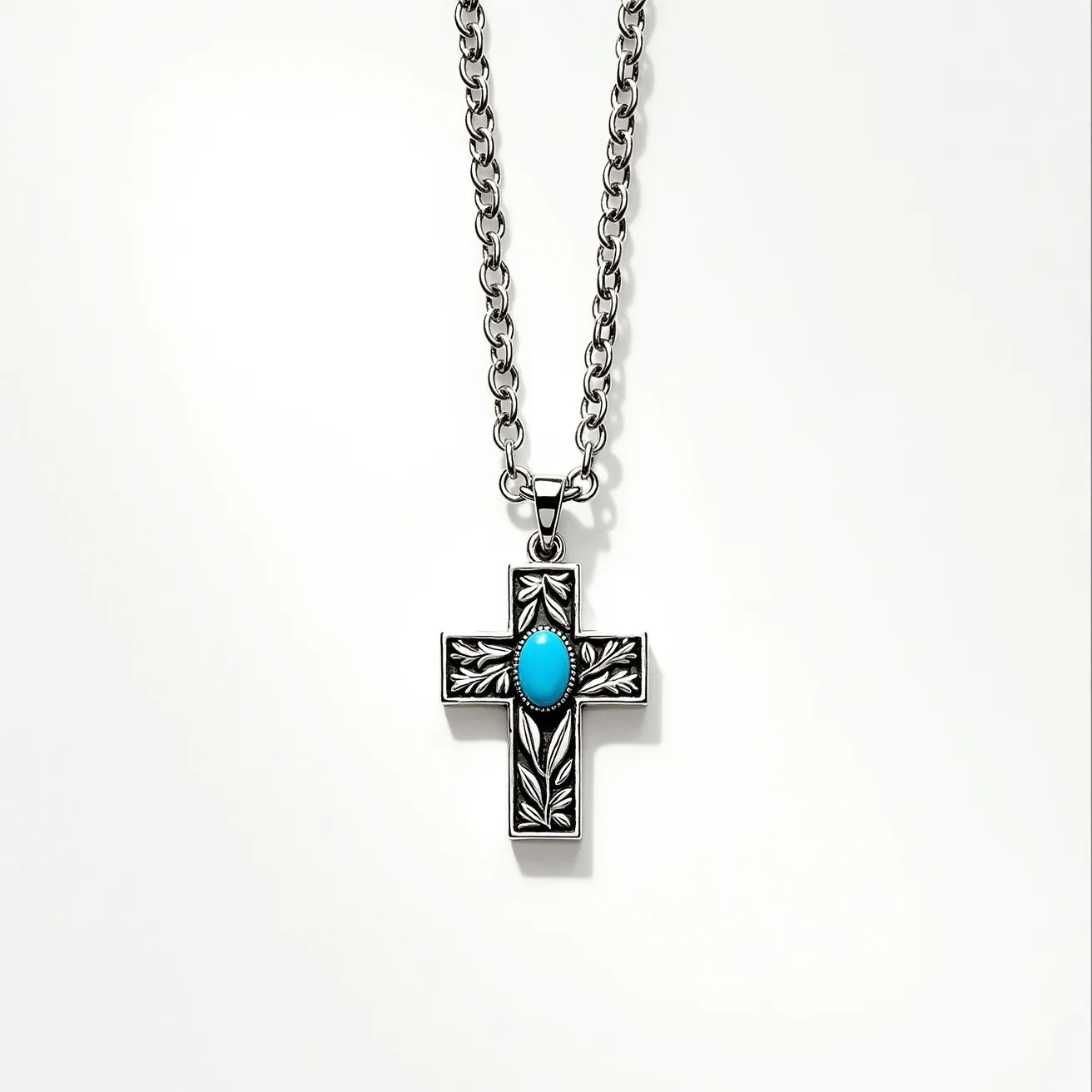 This kids cross necklace features a robust silver-tone chain and a cross pendant adorned with a vibrant turquoise stone set in the center. The cross is intricately designed with detailed engravings that enhance its aesthetic appeal. The stone is an oval cabochon, smoothly polished, and securely set within the pendant, likely held by a bezel setting that complements the design. The necklace chain is equipped with a sturdy clasp that ensures secure wearing. Overall, the combination of the silver-tone material with the turquoise stone creates a striking and fashionable accessory for children.