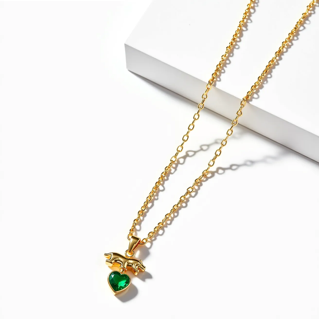 This kids gold necklace features a delicate chain crafted from polished yellow gold, providing a bright and attractive finish. The centerpiece is a pendant adorned with a heart-shaped green gemstone, which is securely set to ensure durability. Above the gemstone, an elegantly designed animal motif adds a whimsical touch to the piece. The necklace is likely to have a secure clasp that complements the overall design, ensuring ease of wear for a child while maintaining a stylish appeal.